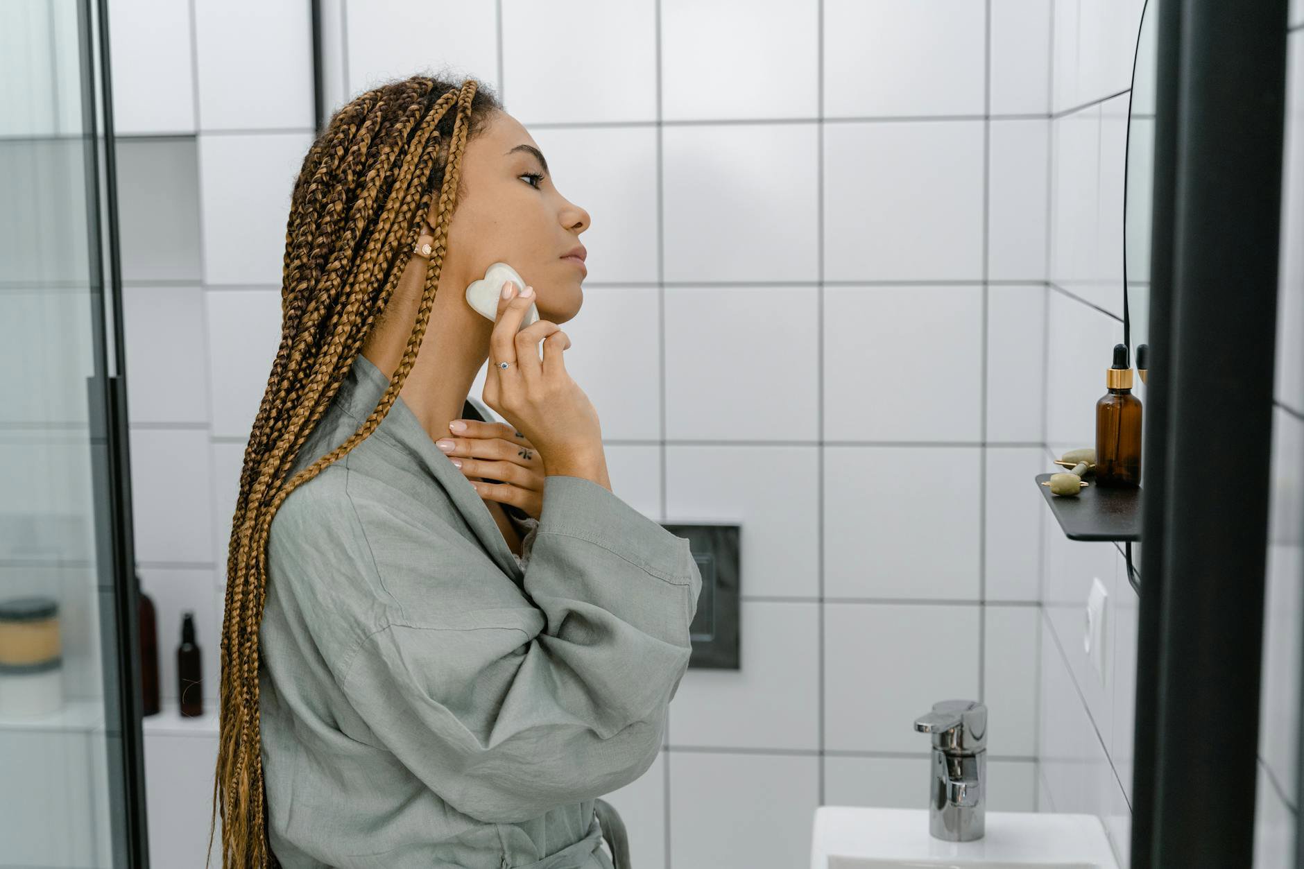 woman doing skincare routine bathroom shelf