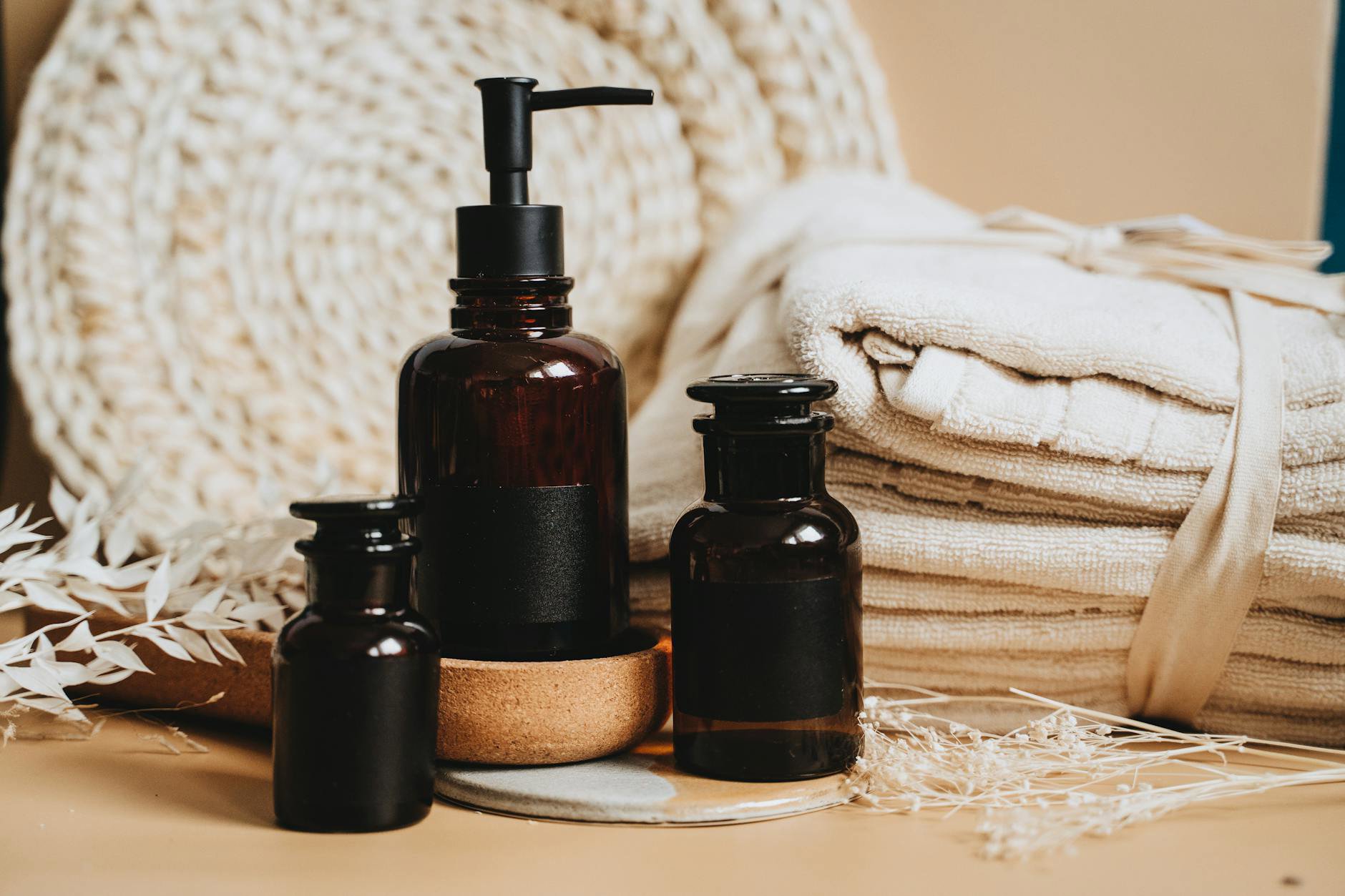 skincare products flatlay face mist and towels