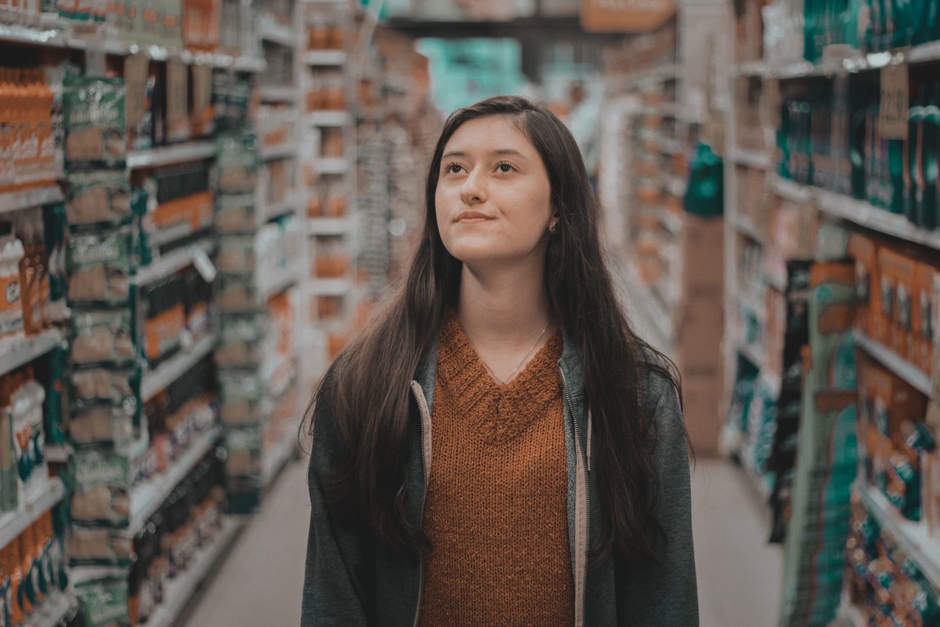 drugstore beauty aisle woman comparing products