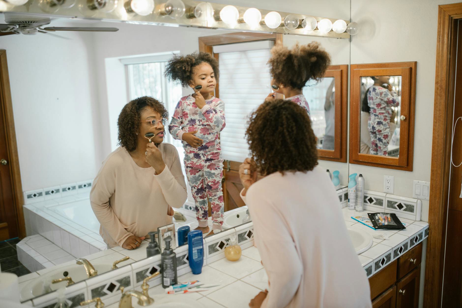 mother and daughter skincare routine bathroom