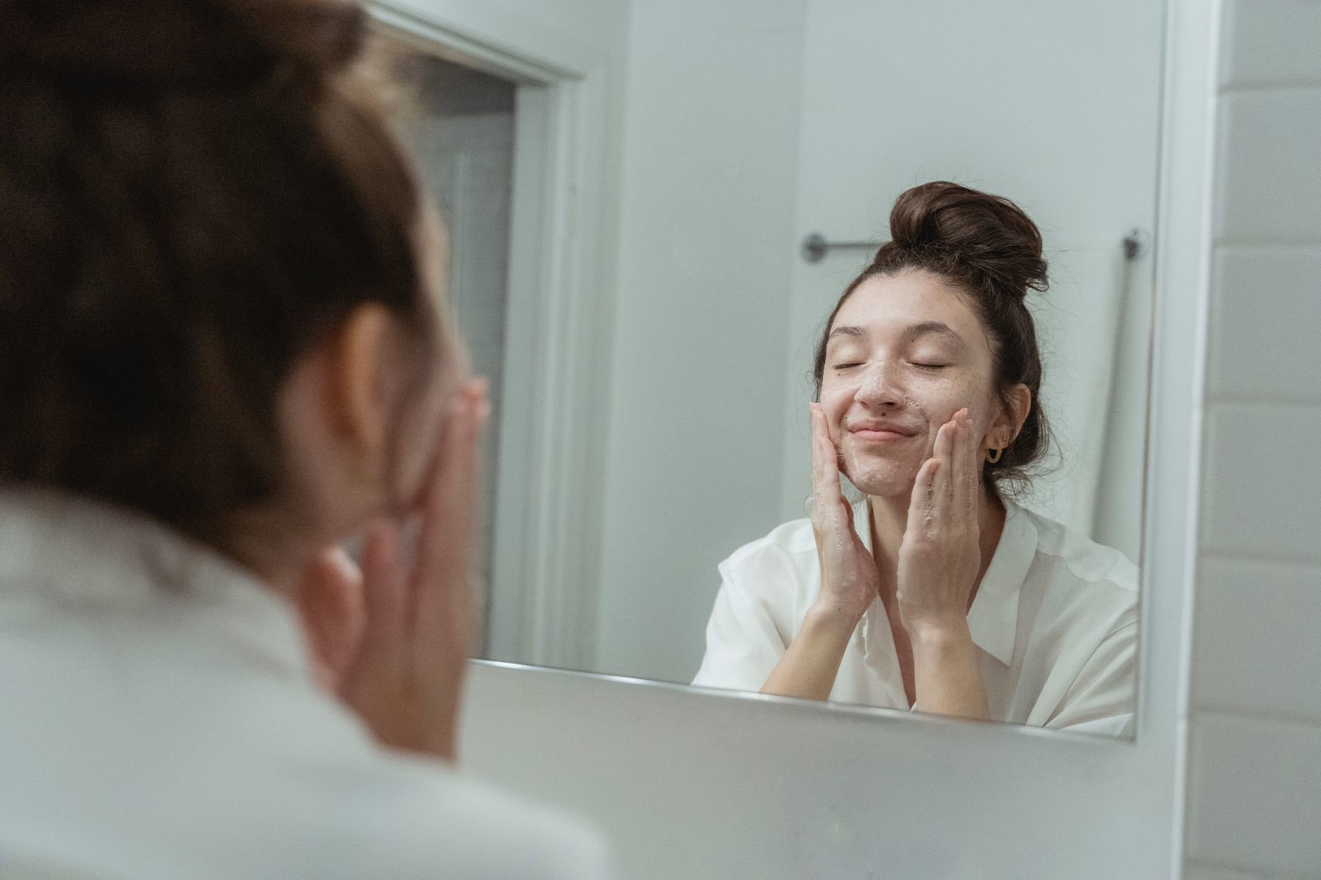 gentle facial cleansing with cream cleanser sink