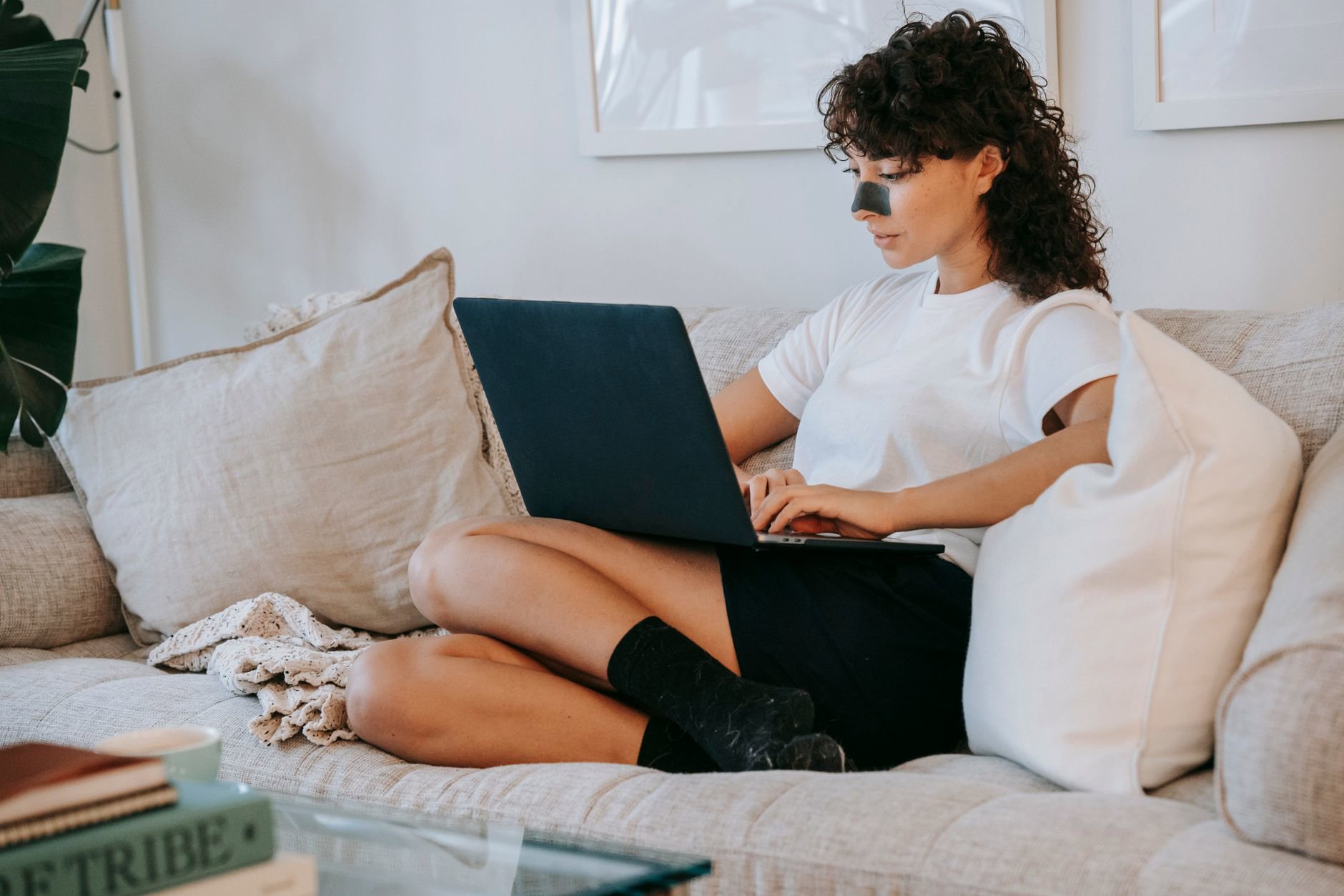 woman browsing skincare sale on laptop at home