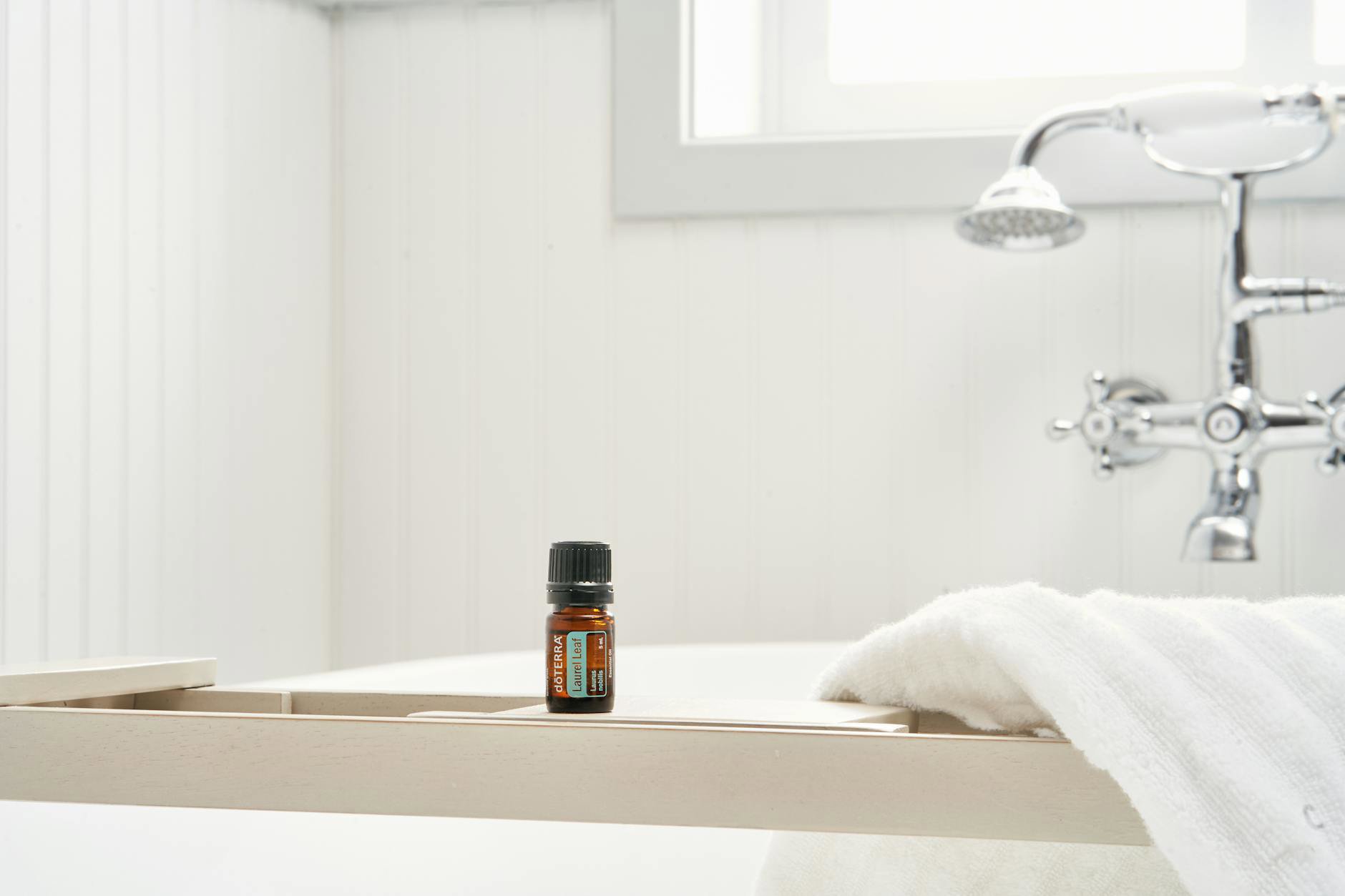 bath oil bottle on bathtub ledge