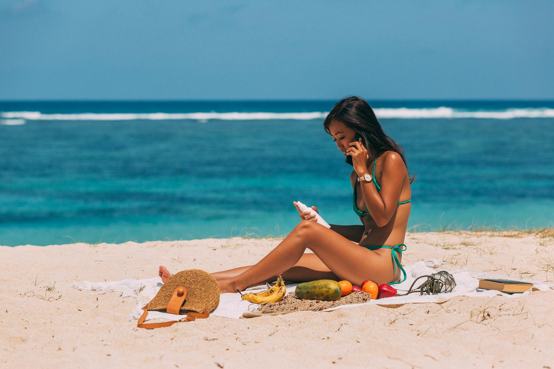 woman holding sunscreen bottle checking expiration date