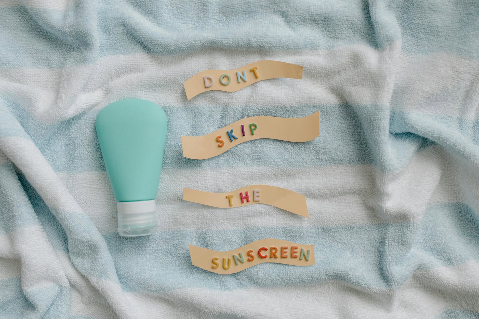 sunscreen bottle in beach bag shade