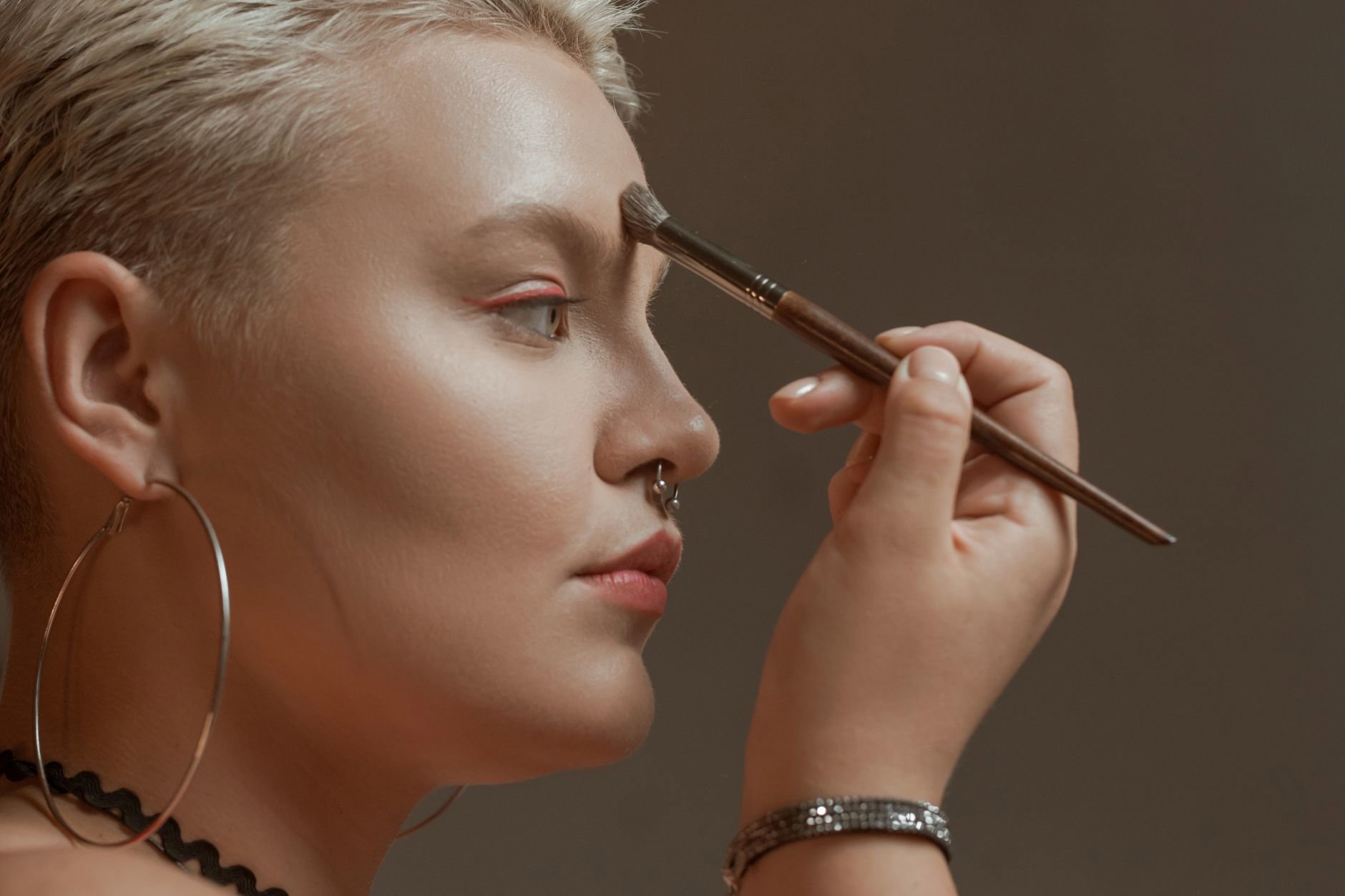close up eye applying bronzer in crease with fluffy brush