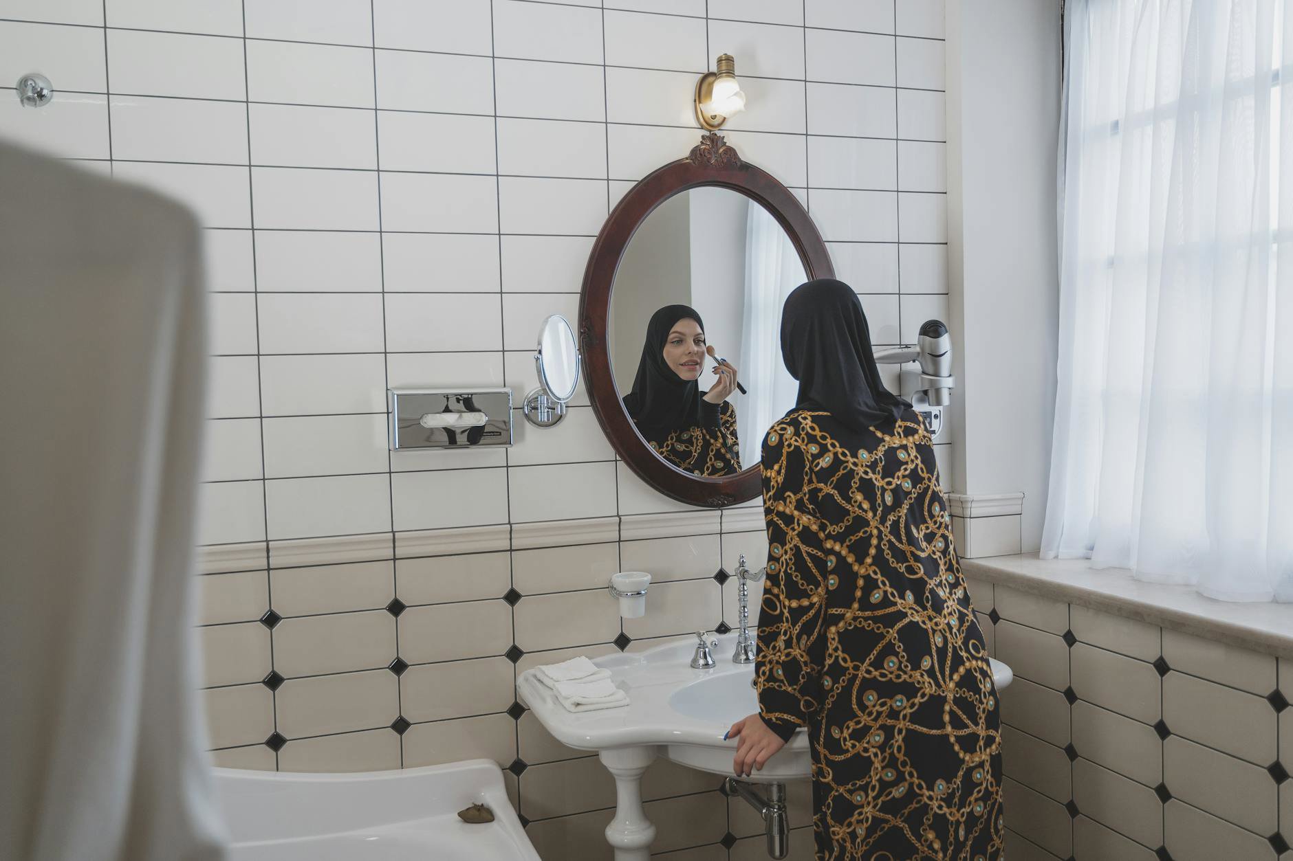 woman applying moisturizer bathroom mirror