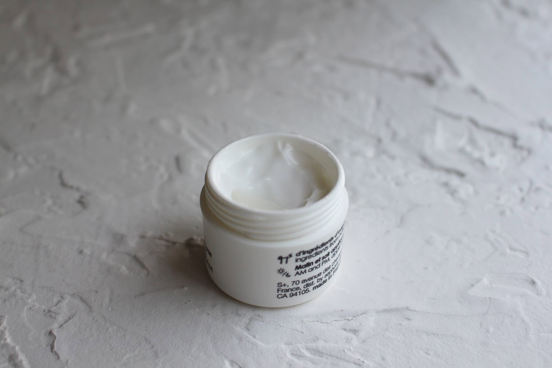 eye cream jar open bathroom counter