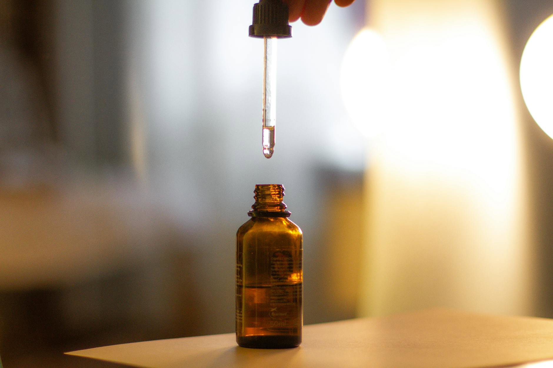 close up of face oil dropper amber bottle