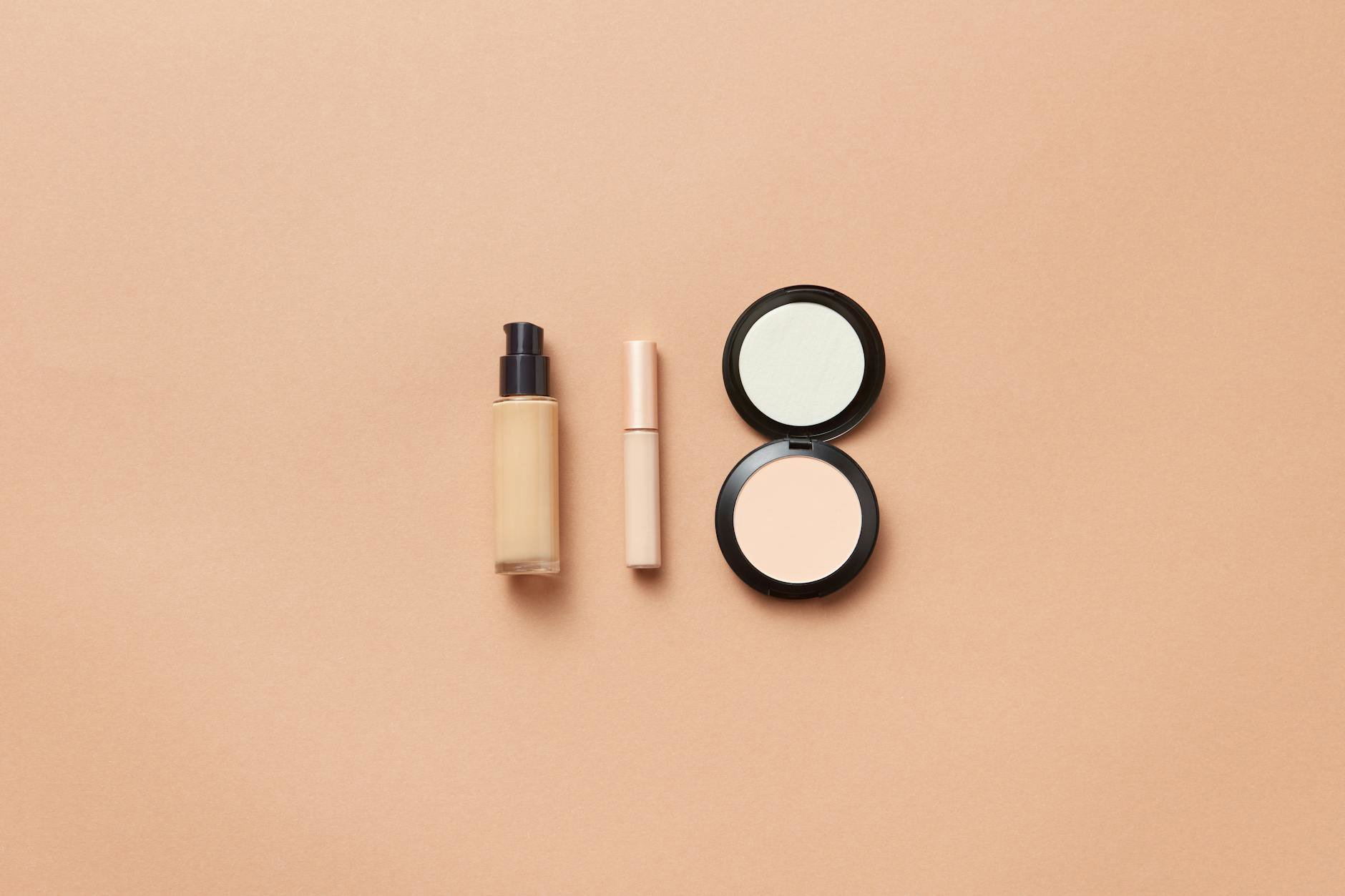 concealer tubes flatlay clean background