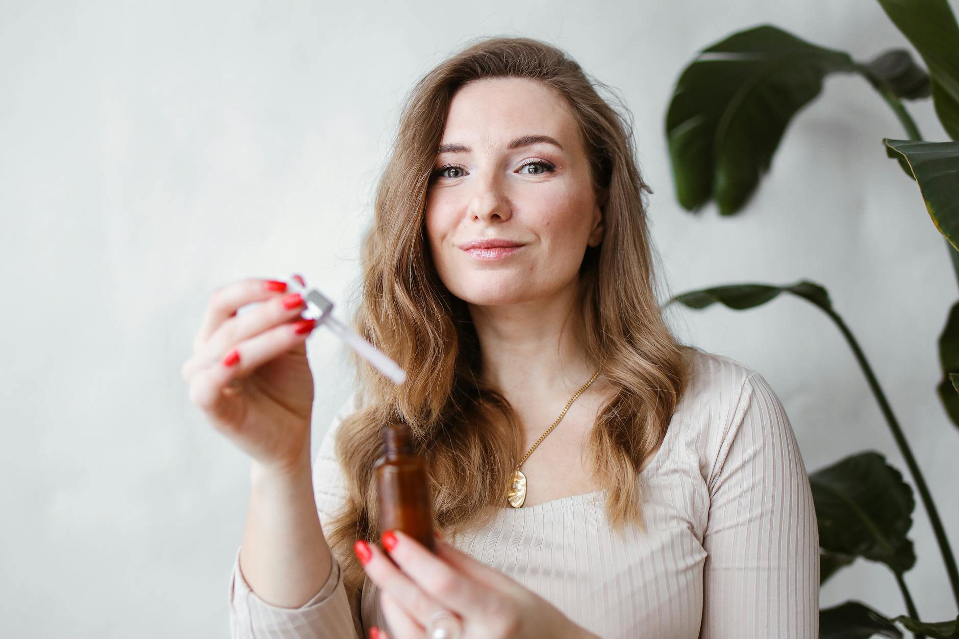 woman comparing skincare serum bottles drugstore shelf