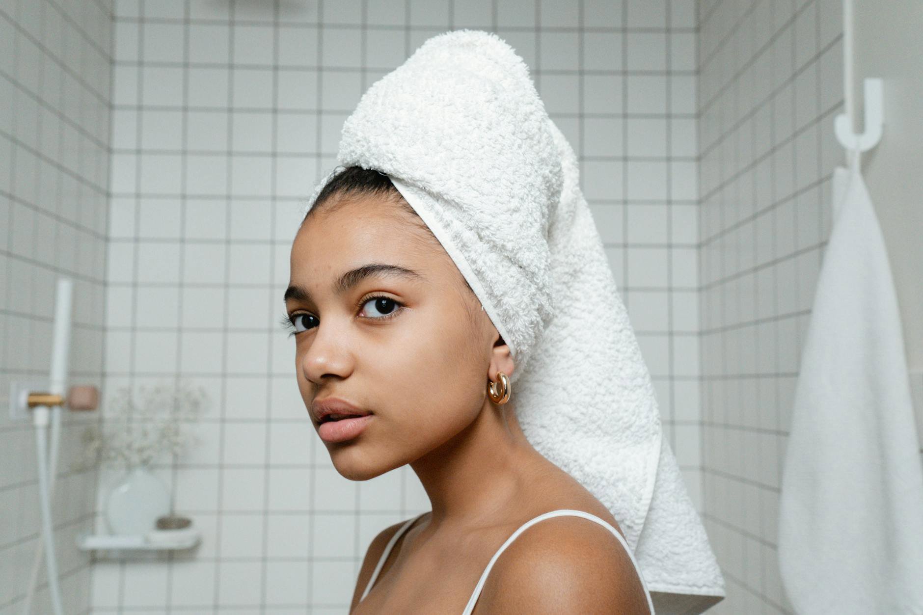 woman showering warm water minimal skincare