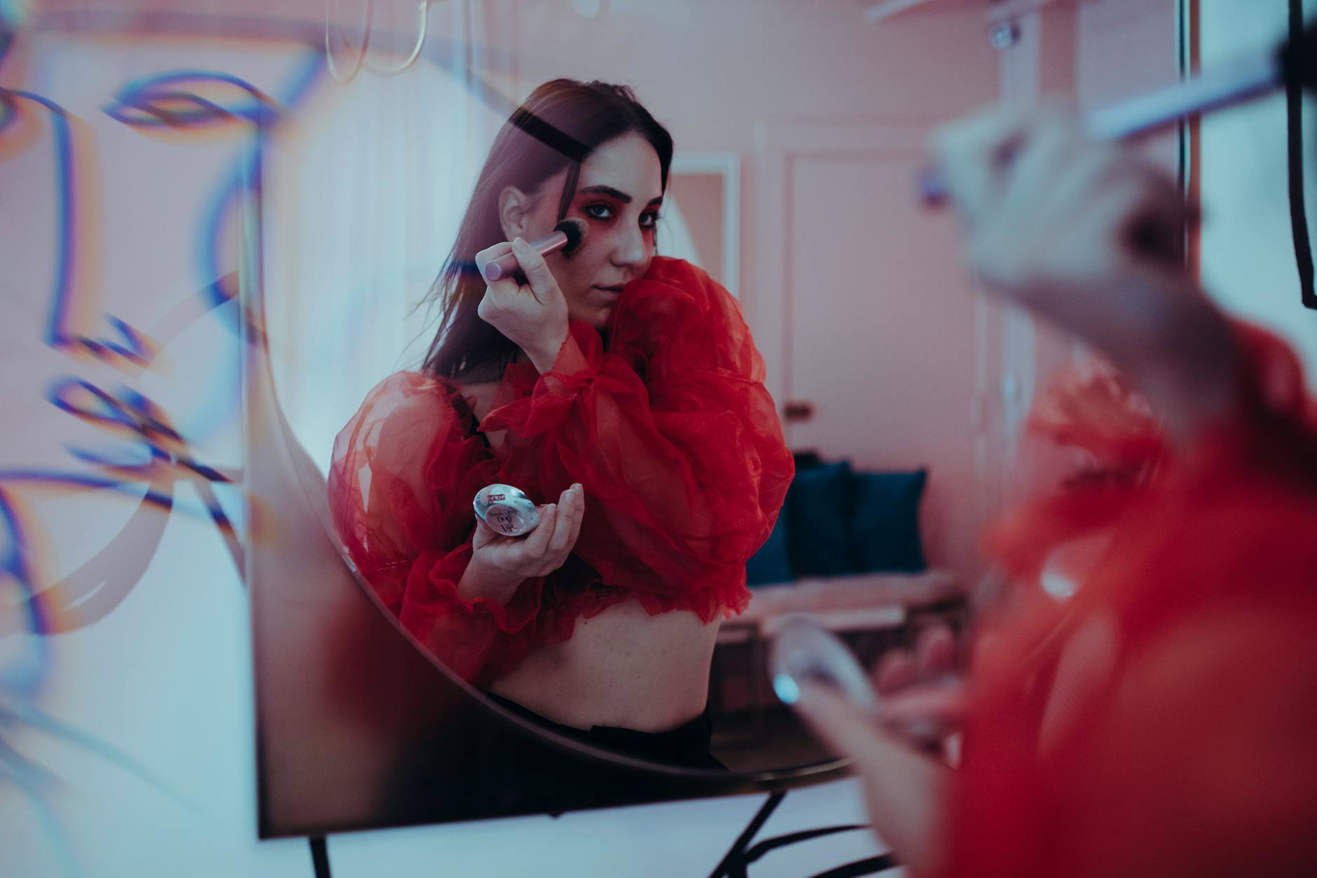 woman applying contour makeup in mirror