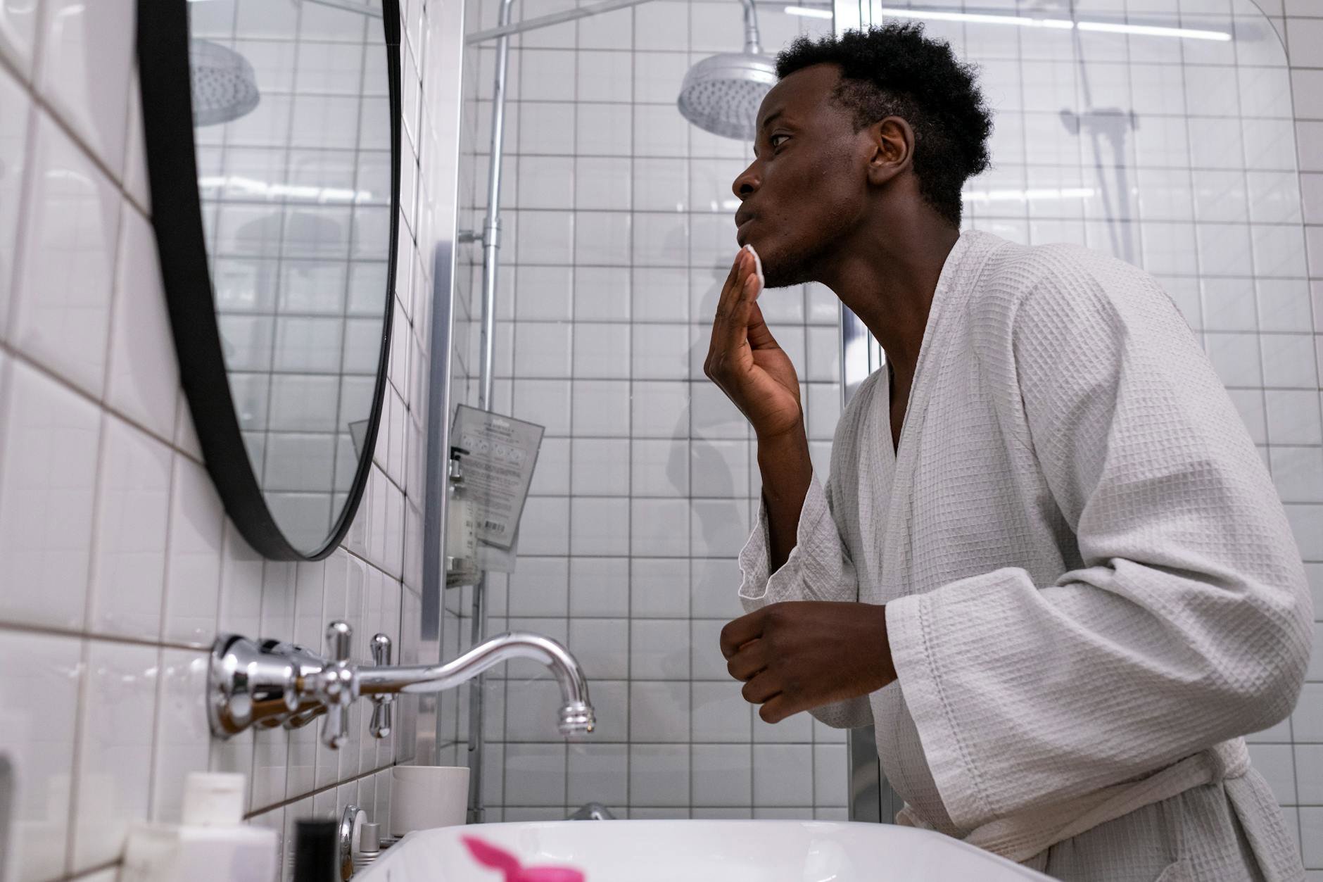 woman skincare routine mirror bathroom