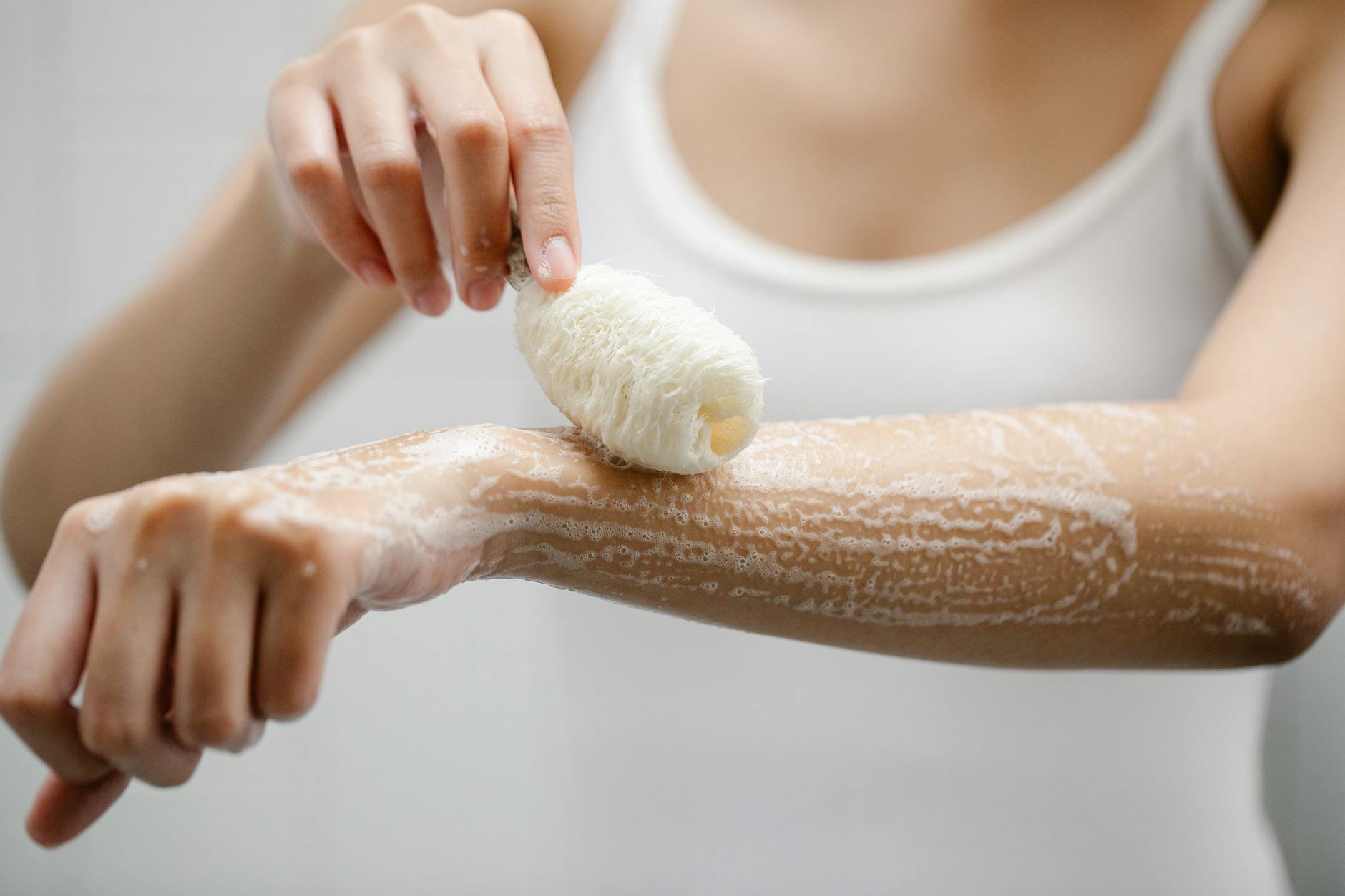 woman showering applying body wash lather