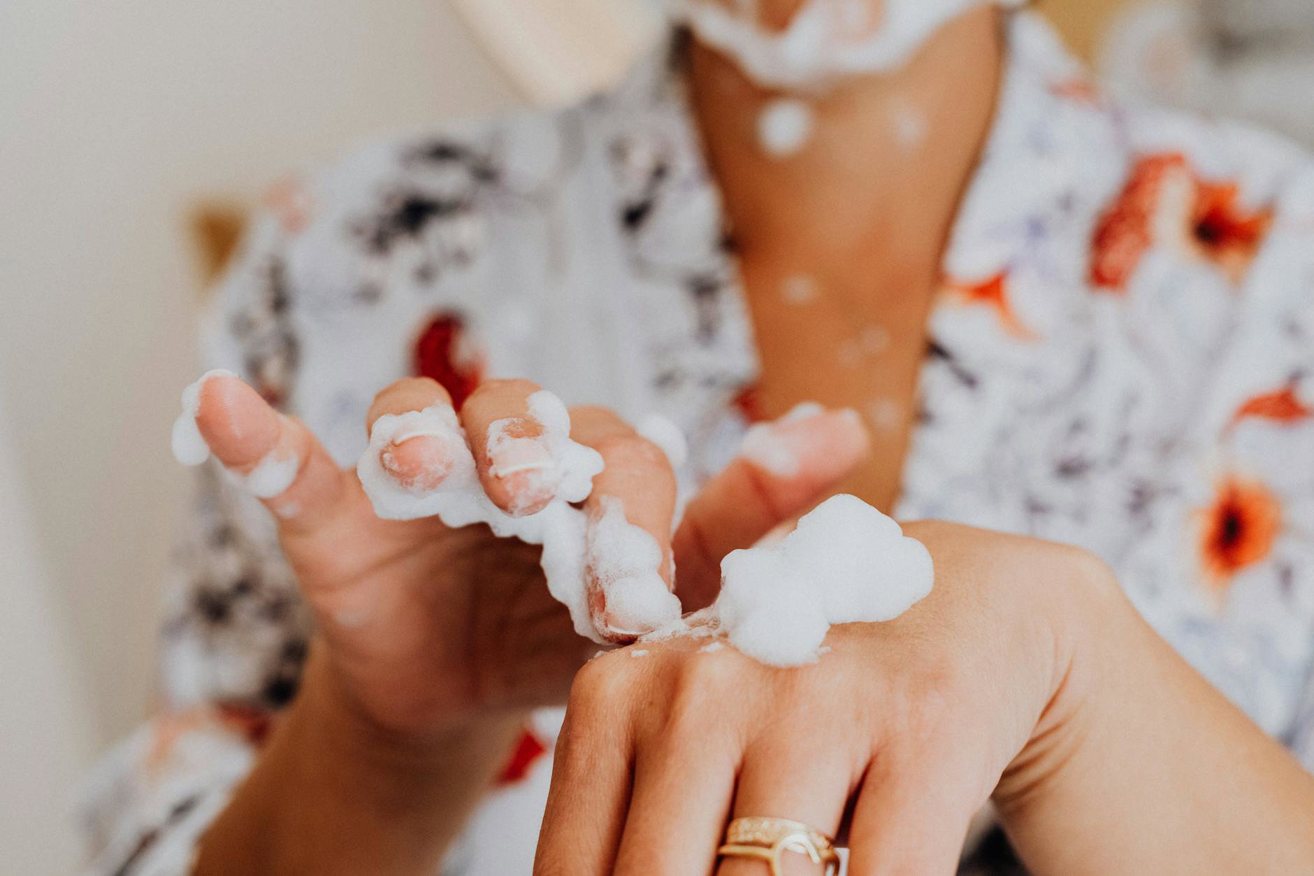 woman washing face with foam cleanser