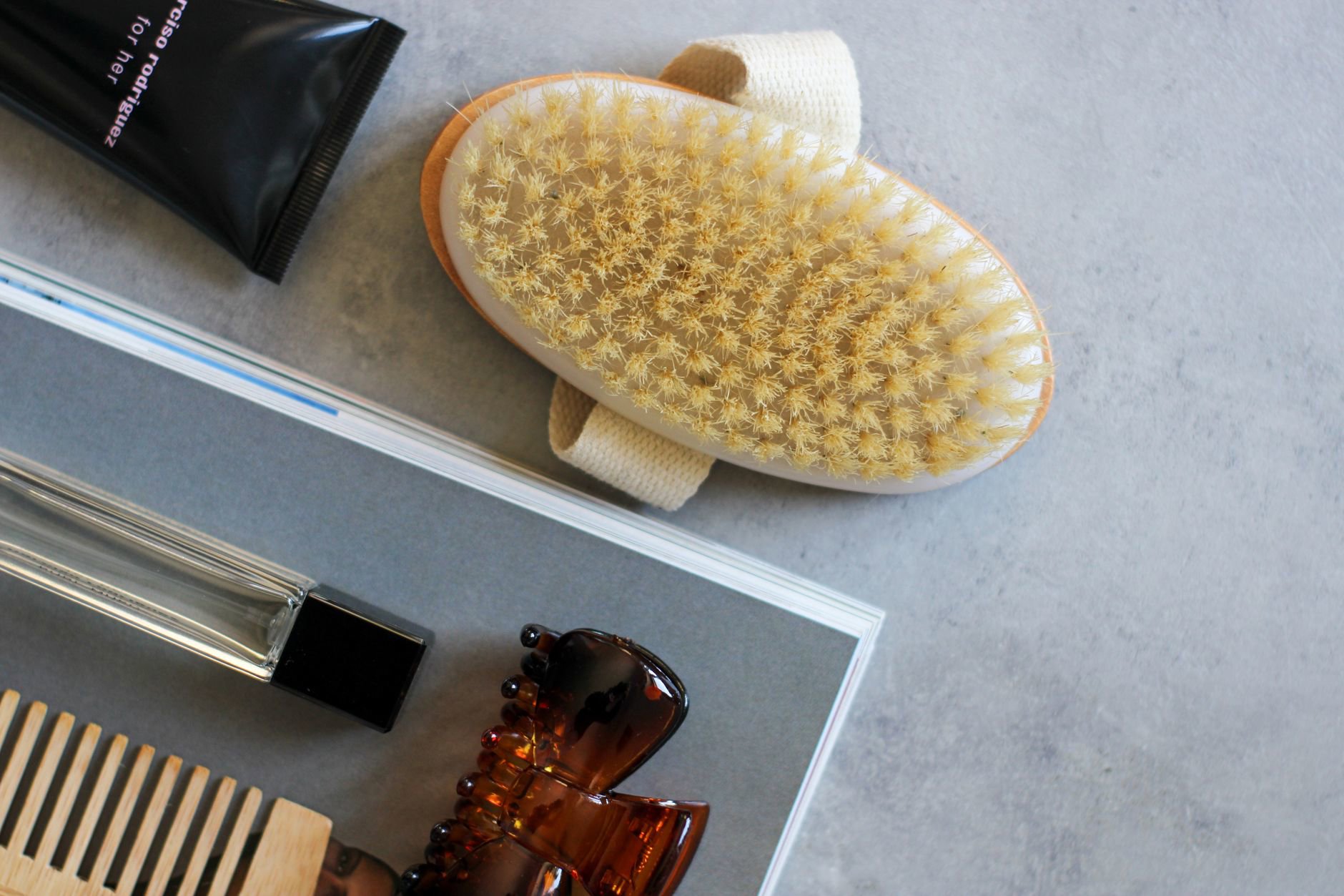 glossy hair serum bottle on vanity with hairbrush