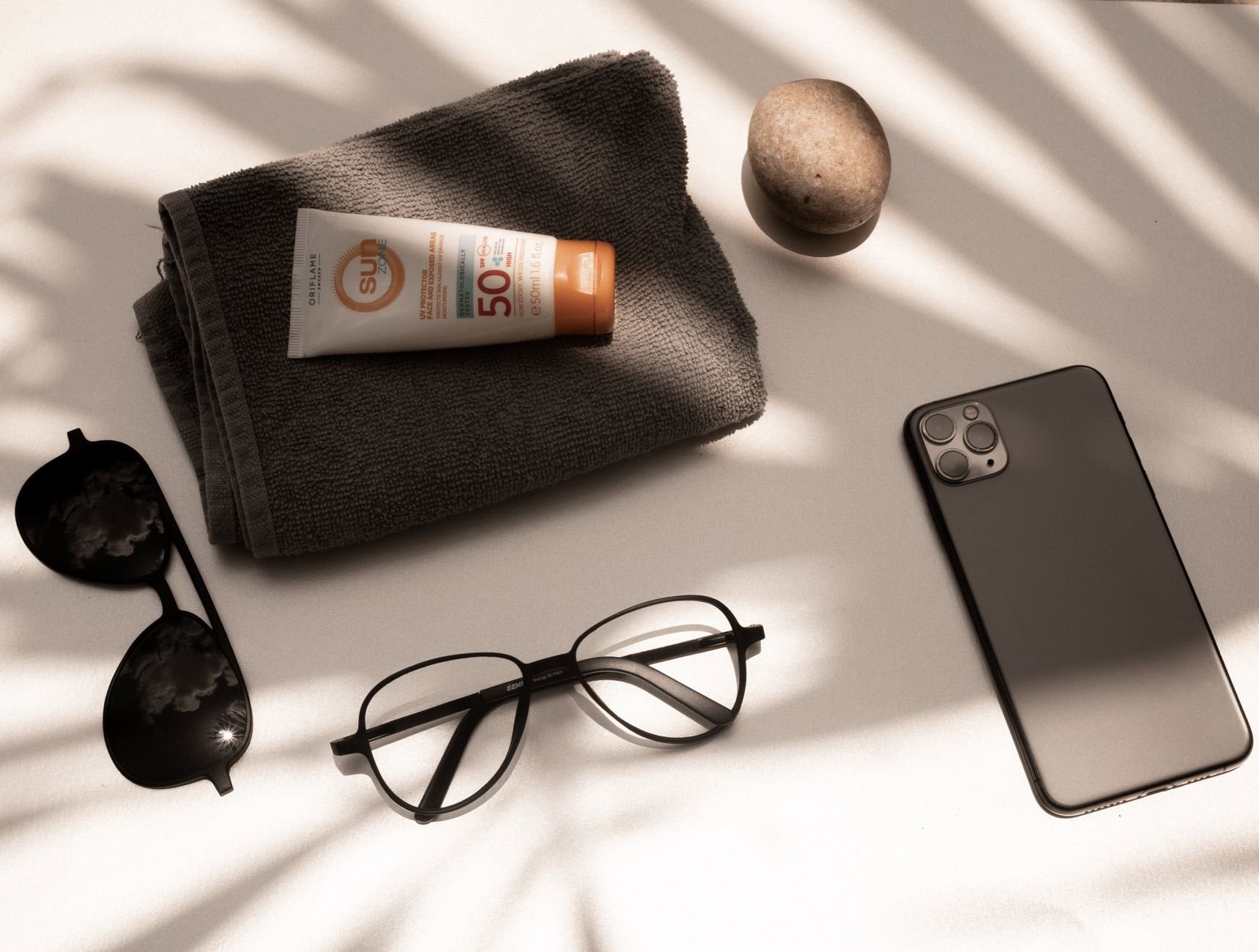 SPF 50 sunscreen tube flatlay on bathroom counter