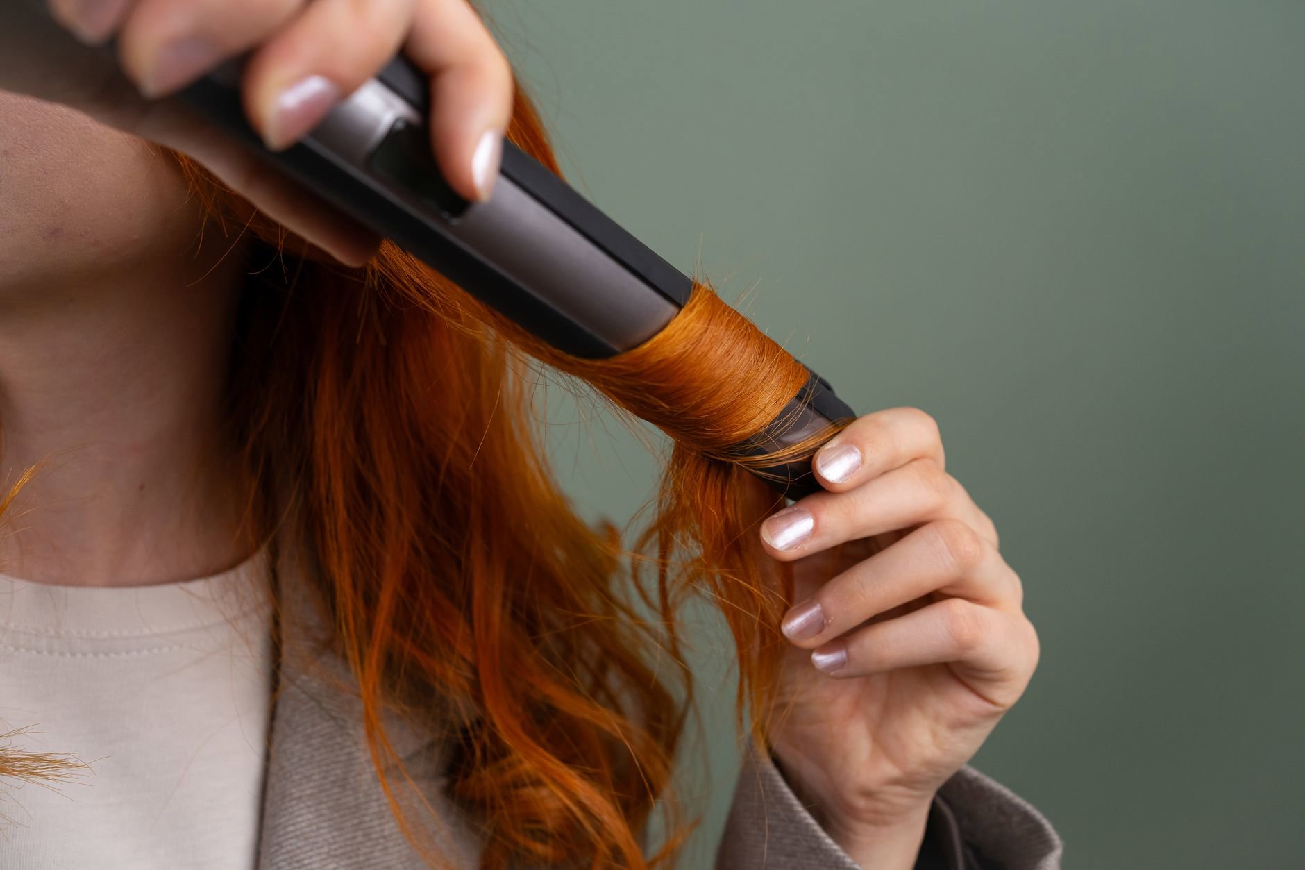 woman scrunching curl cream into wet hair