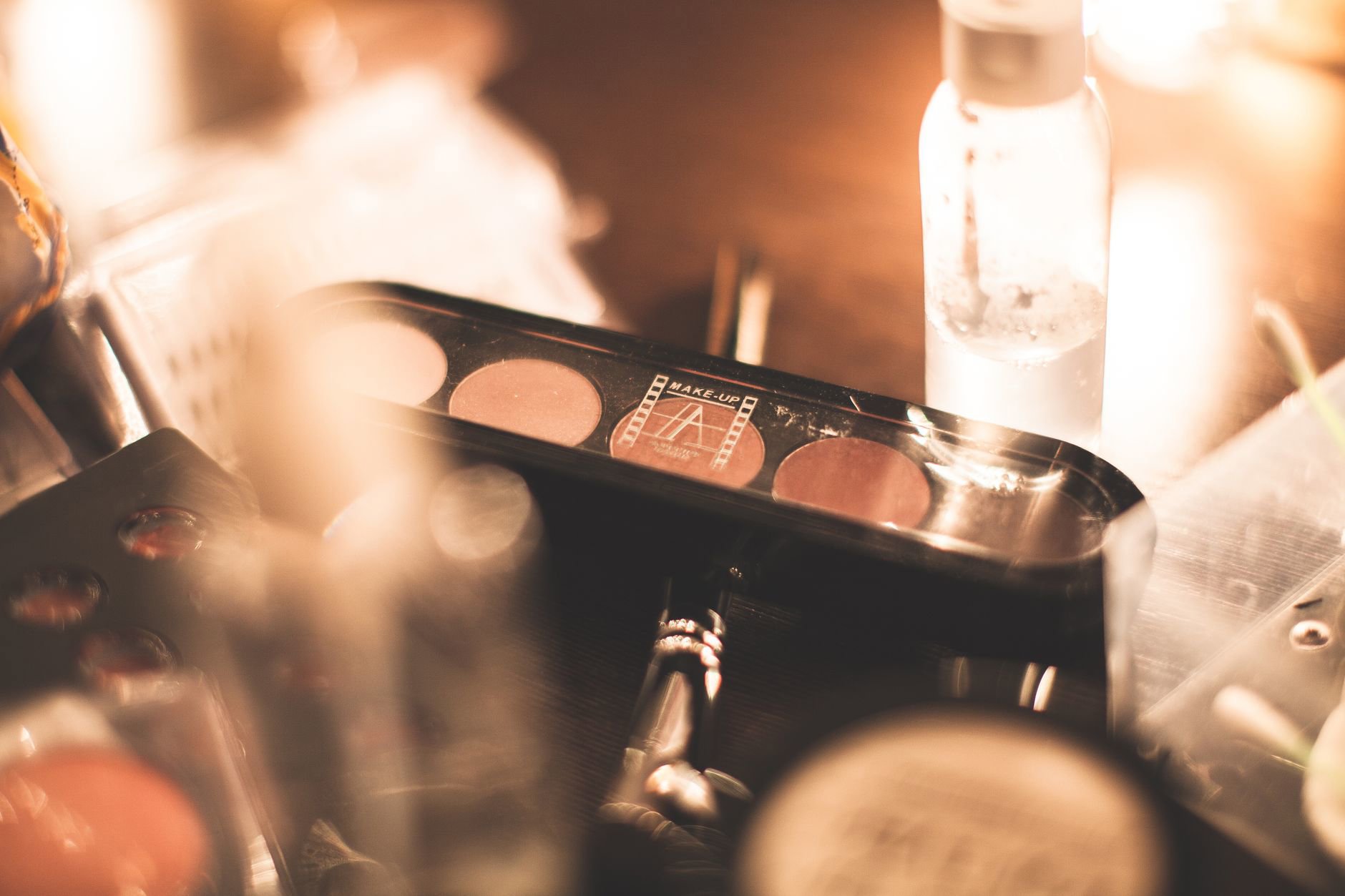 makeup flatlay highlighter compact brush on vanity