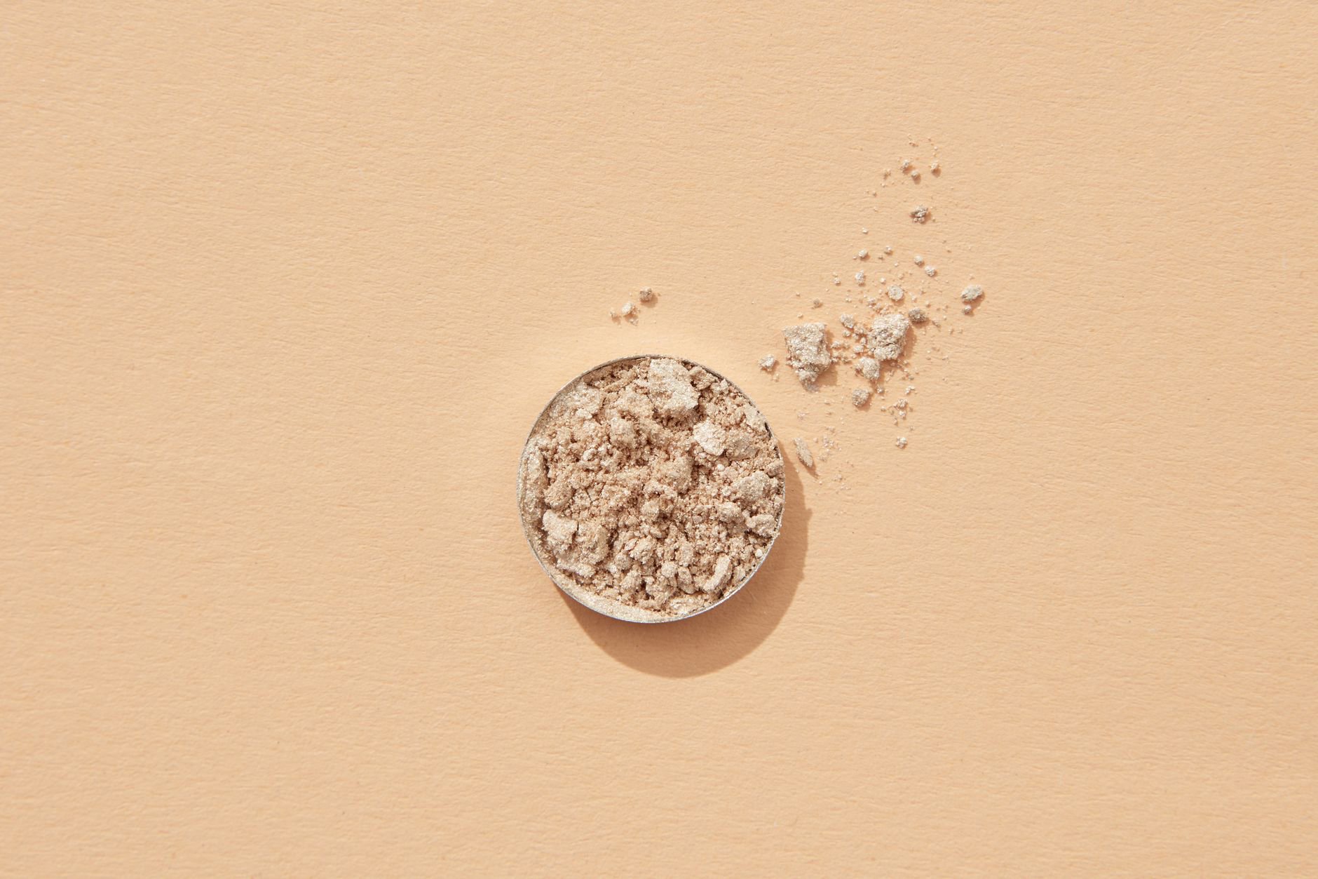 powder highlighter compact swatch on skin