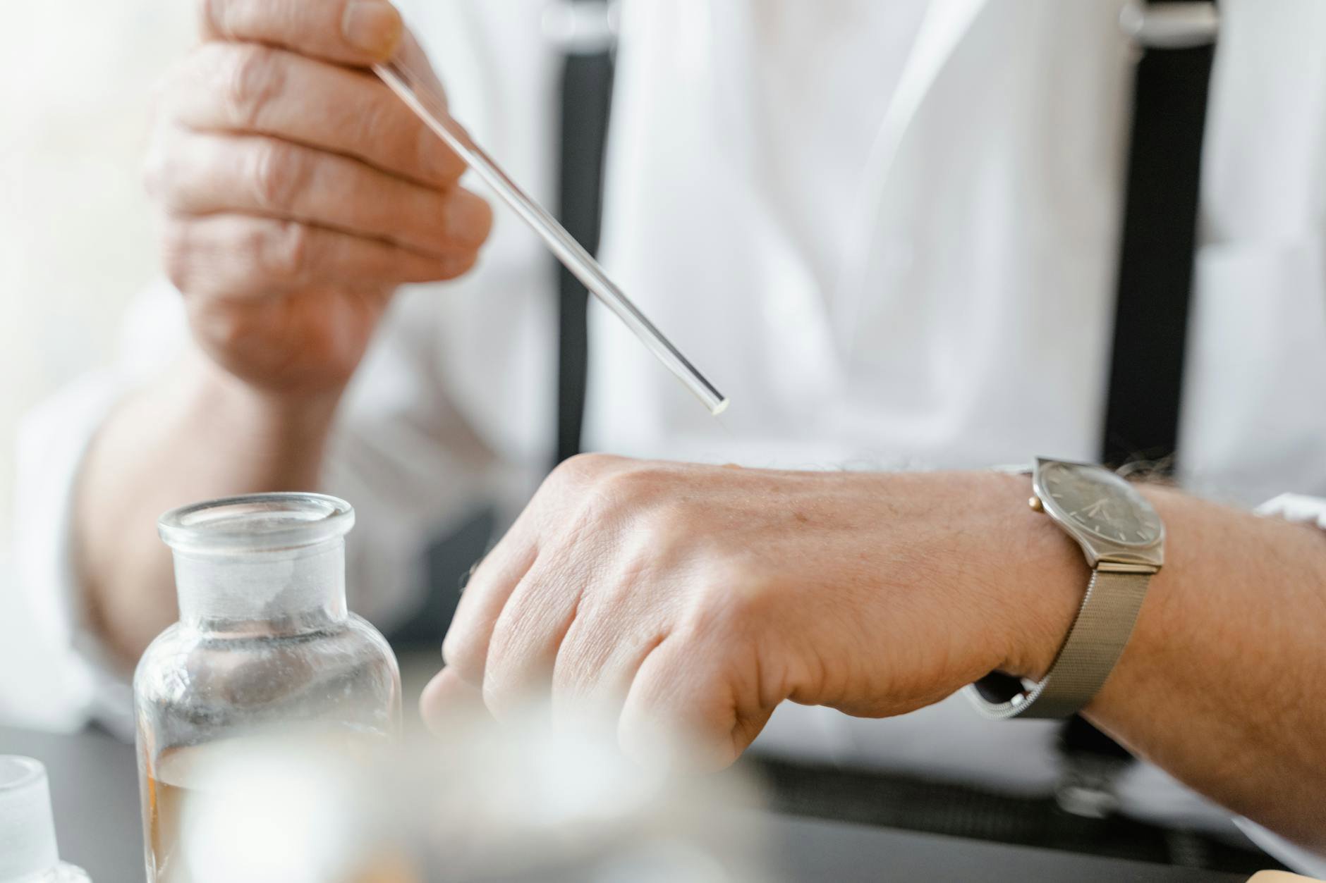 woman testing perfume on wrist in department store
