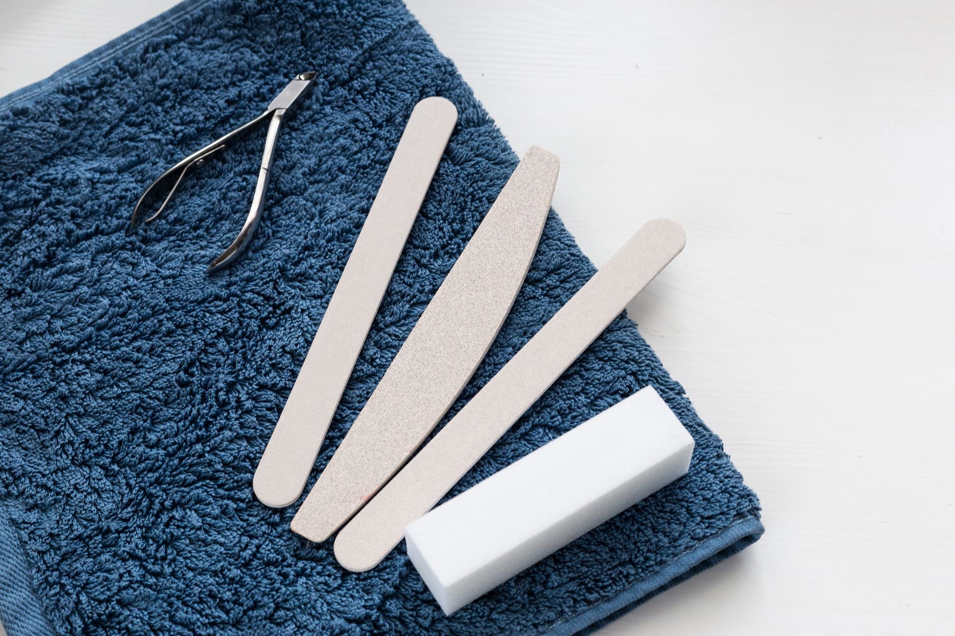 nail care tools flatlay emery board buffer clips