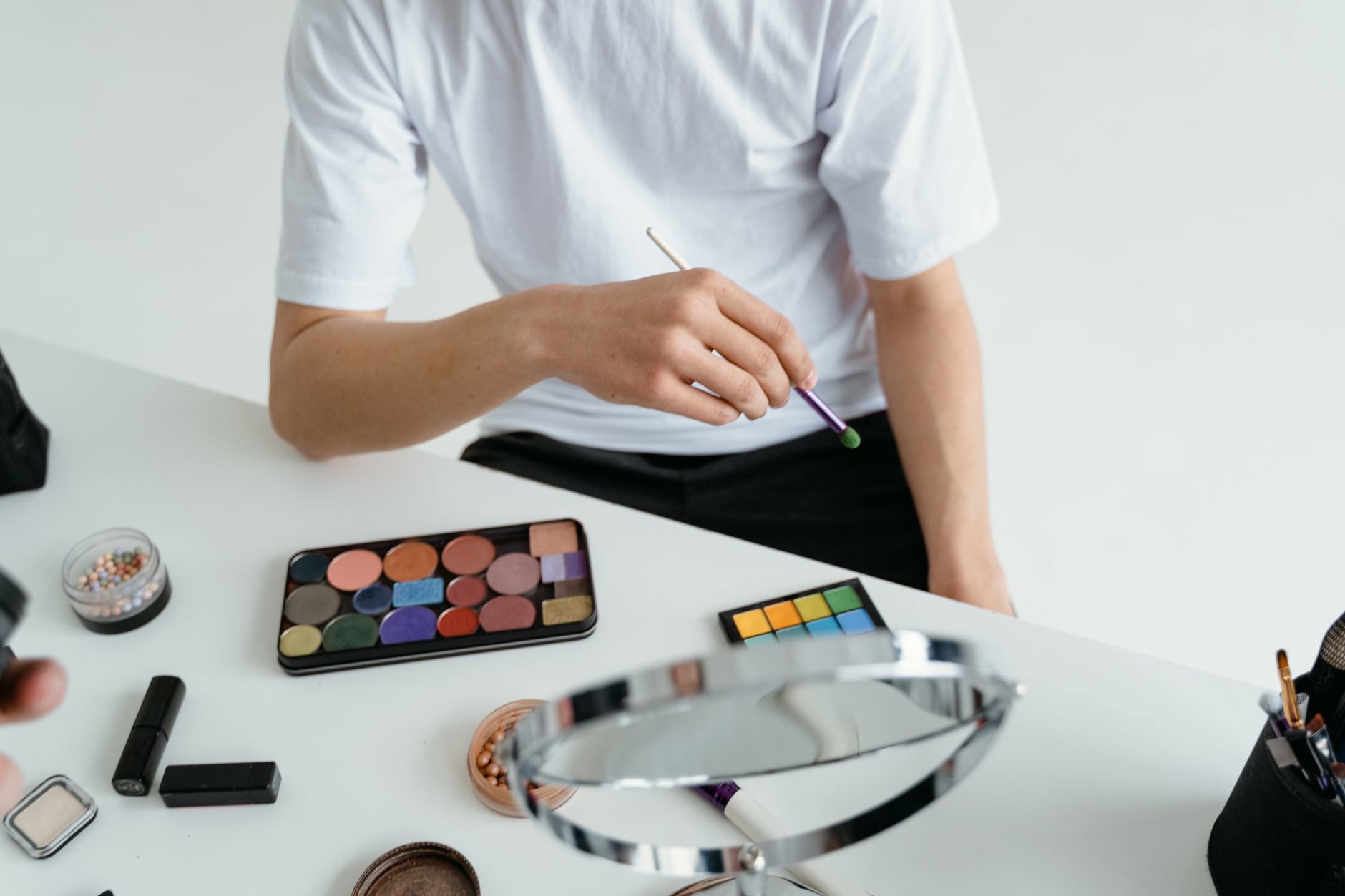 woman choosing brow pencil shades in mirror
