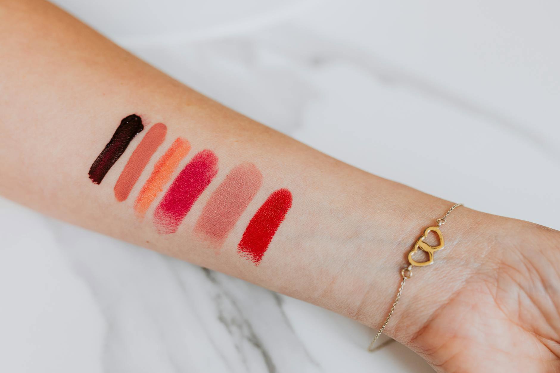 lipstick swatches on arm natural light