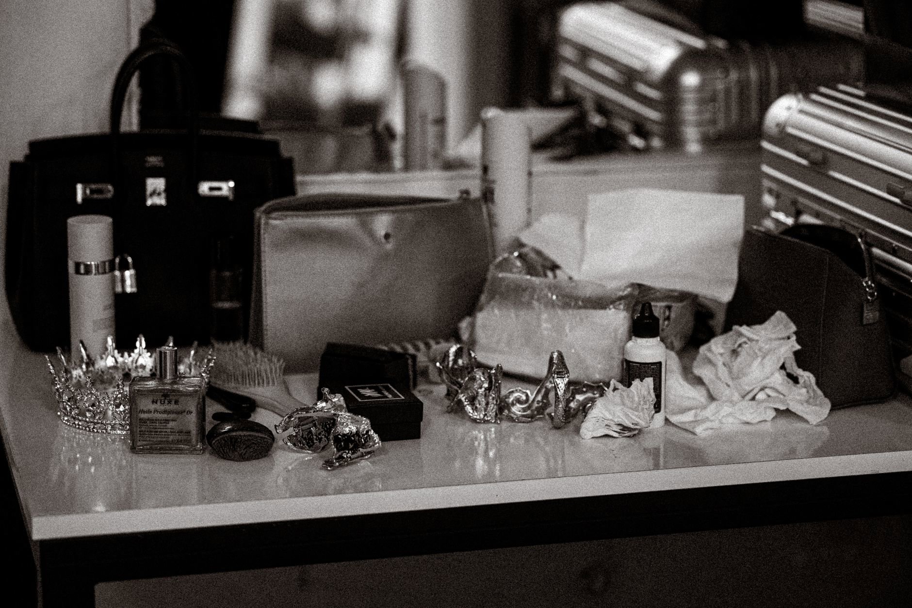 perfume bottle on vanity with lotion and scarf
