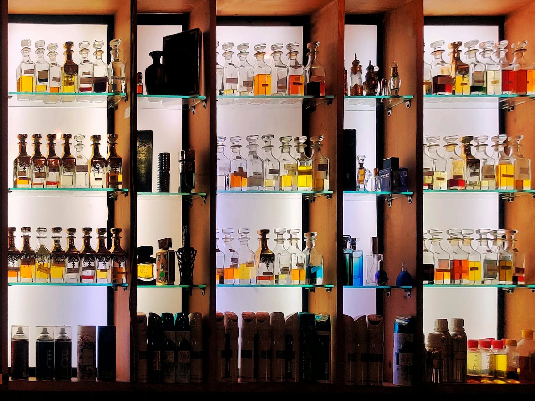 perfume bottles stored in a dark drawer