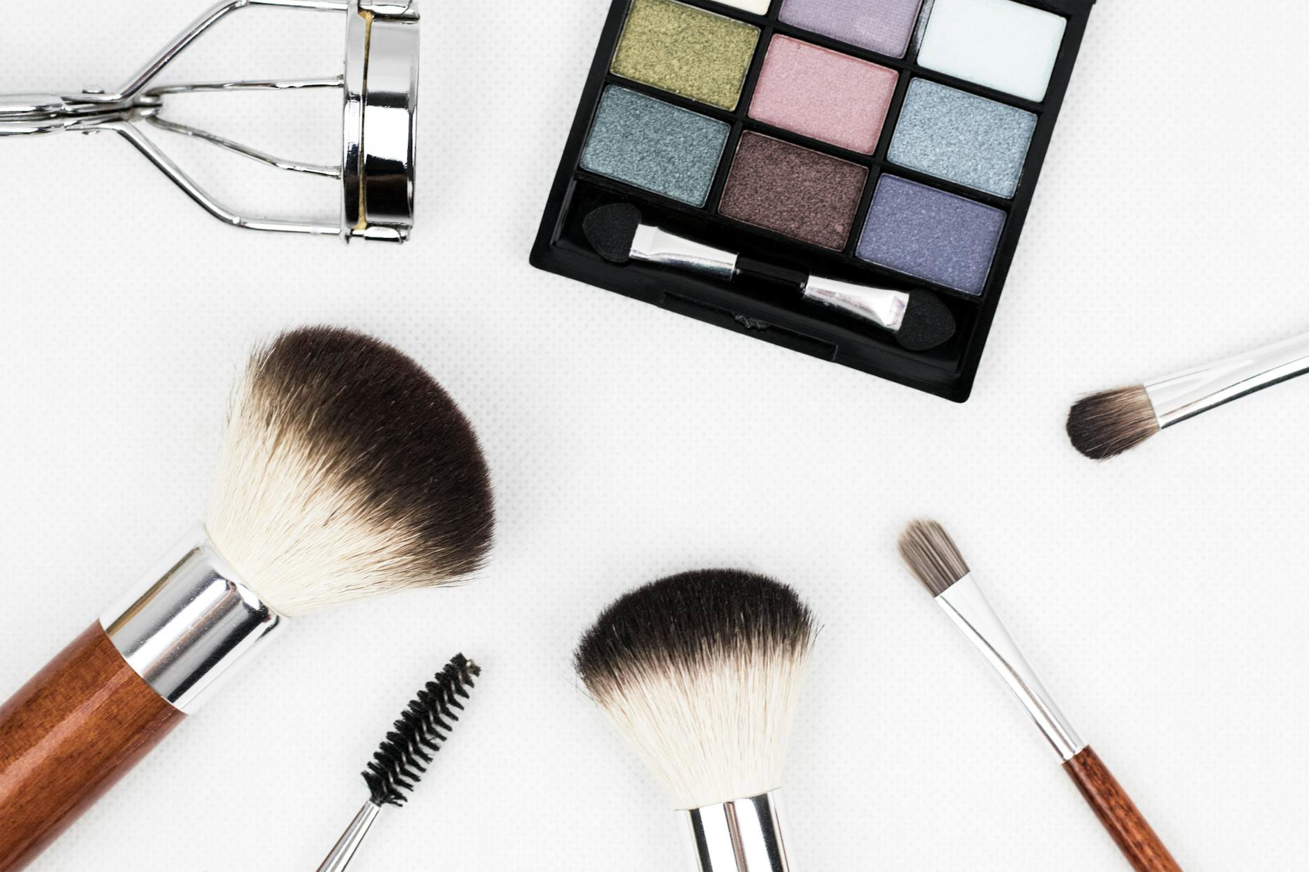 flatlay eyeshadow palette and blending brush on vanity