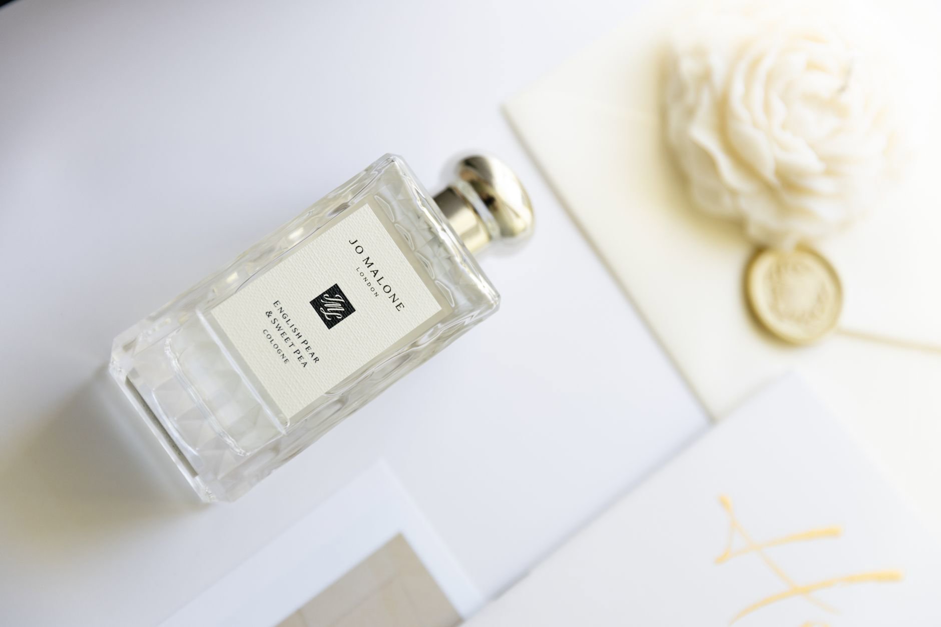 Jo Malone English Pear and Freesia Bath Oil bottle on bath ledge