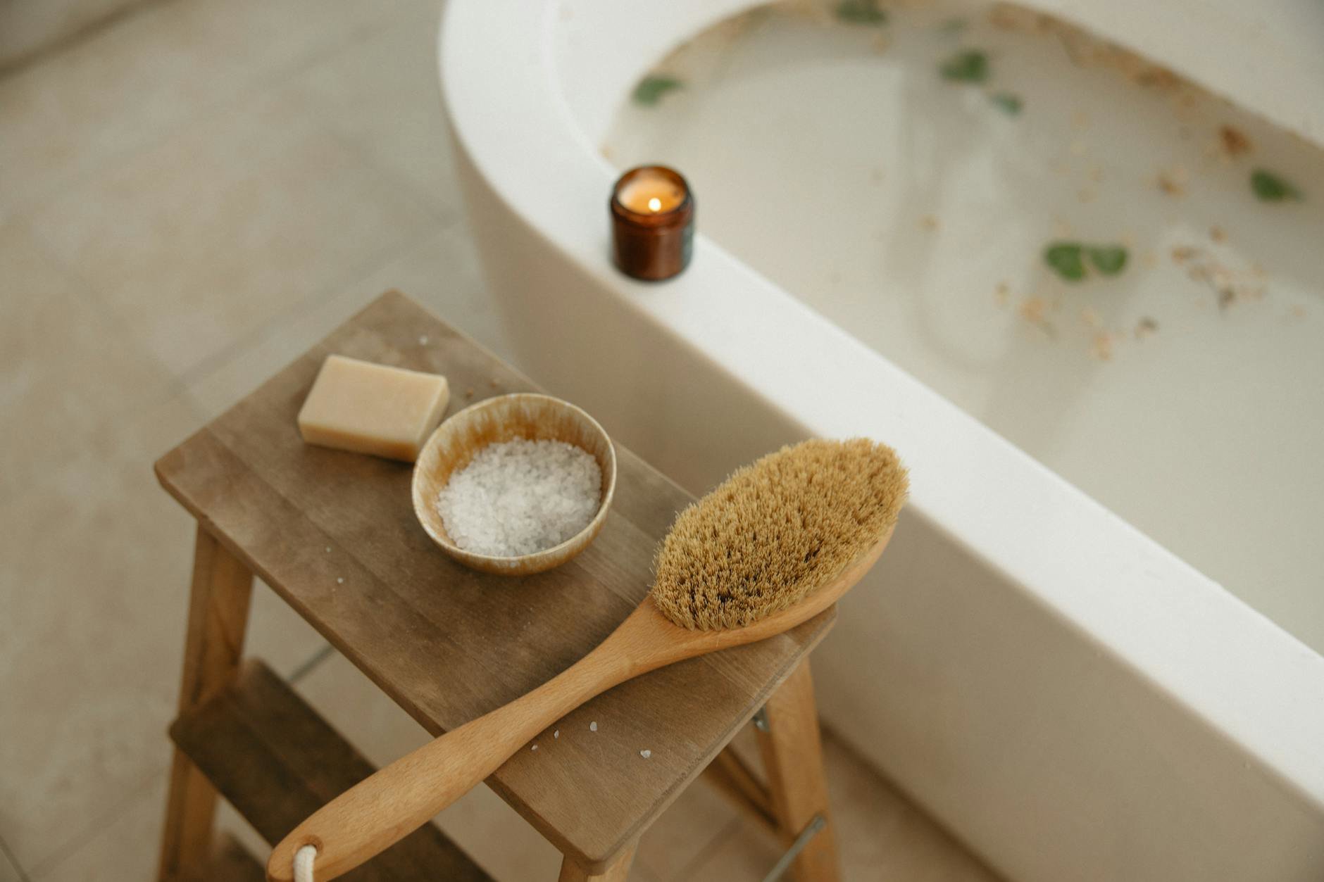 clean bathtub being rinsed after bath oil use
