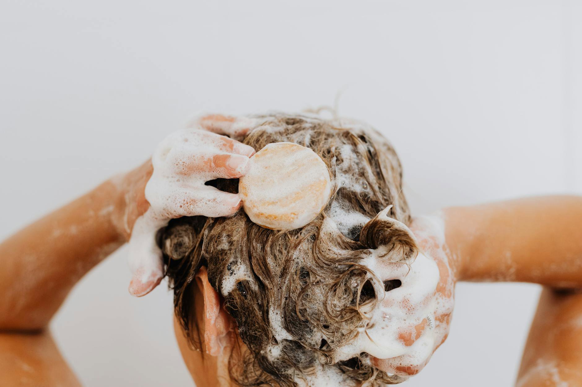 woman washing hair creamy shampoo lather shower