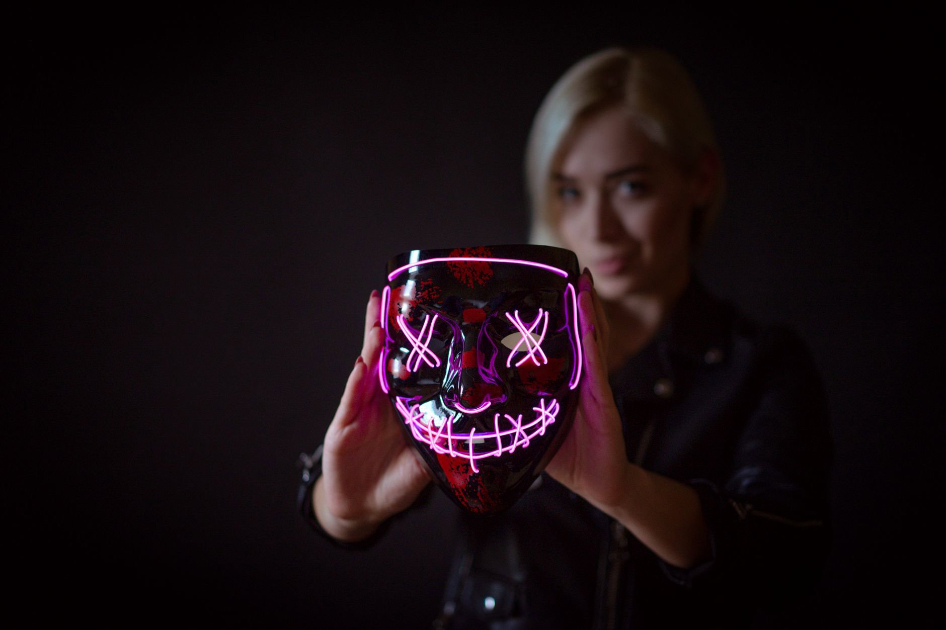 woman wearing LED face mask at home