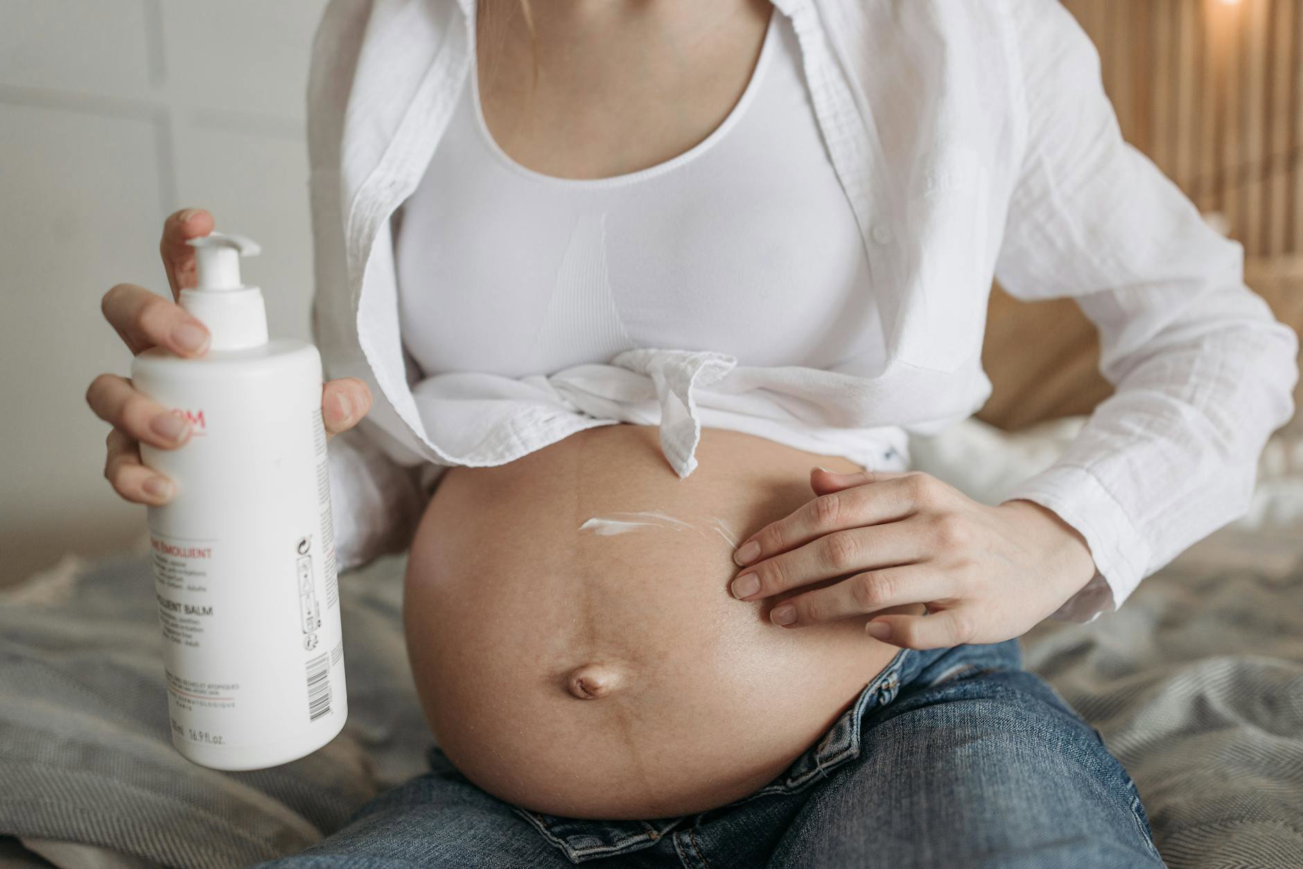 woman applying body lotion after shower eczema prone skin