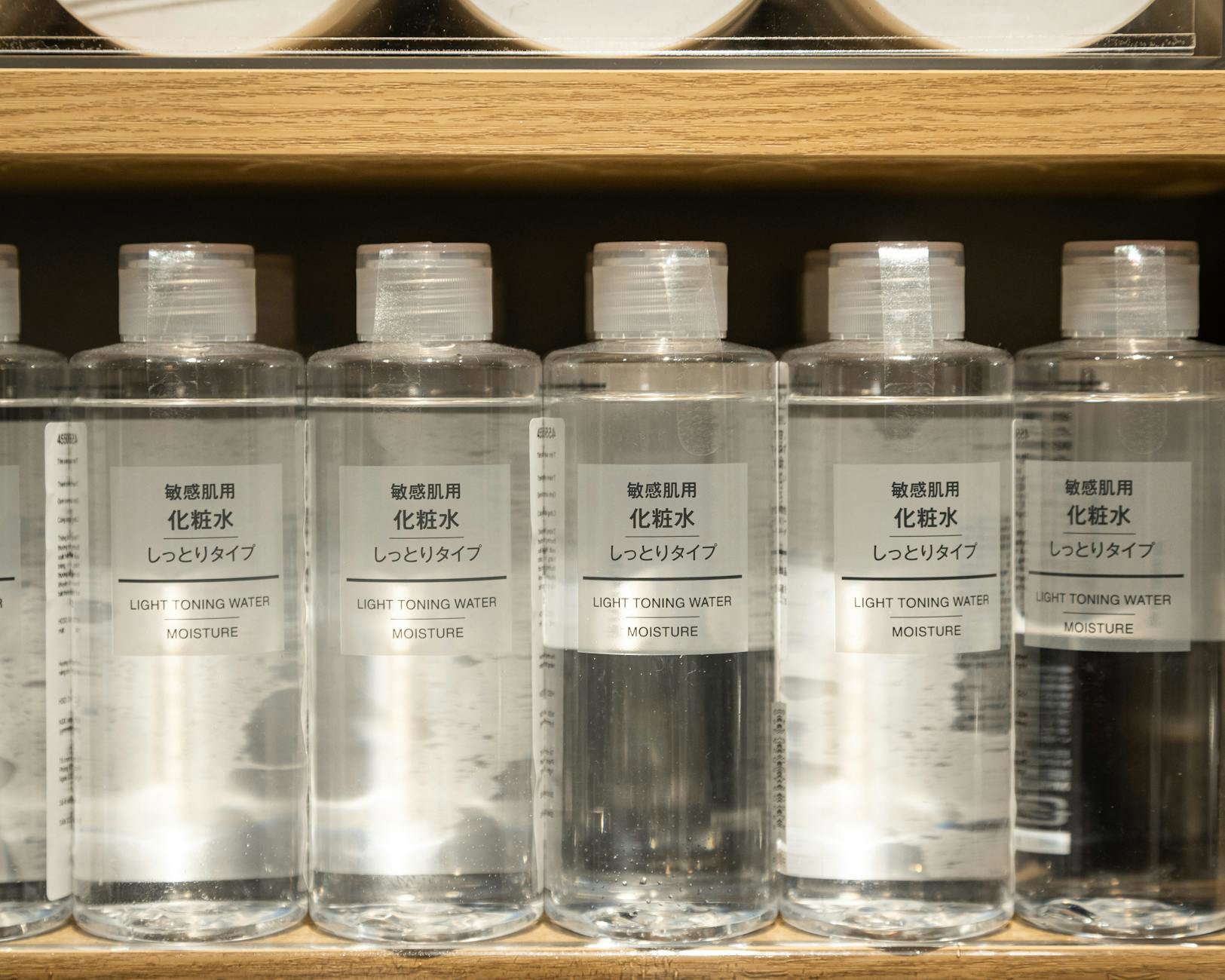 skincare products flatlay toner bottles minimal
