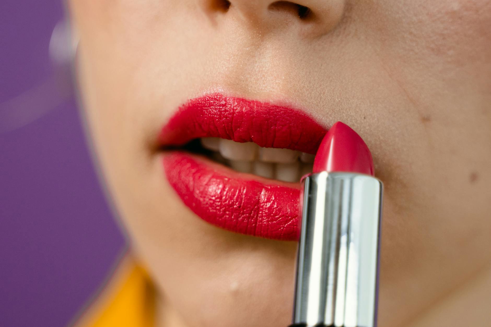 woman applying matte lipstick close-up