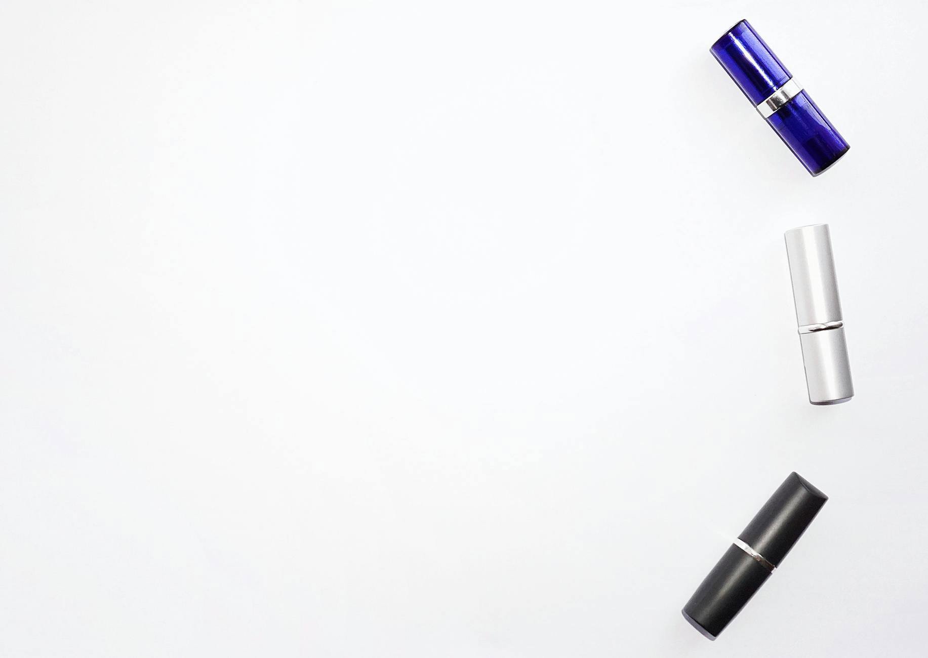 lipsticks flatlay white background