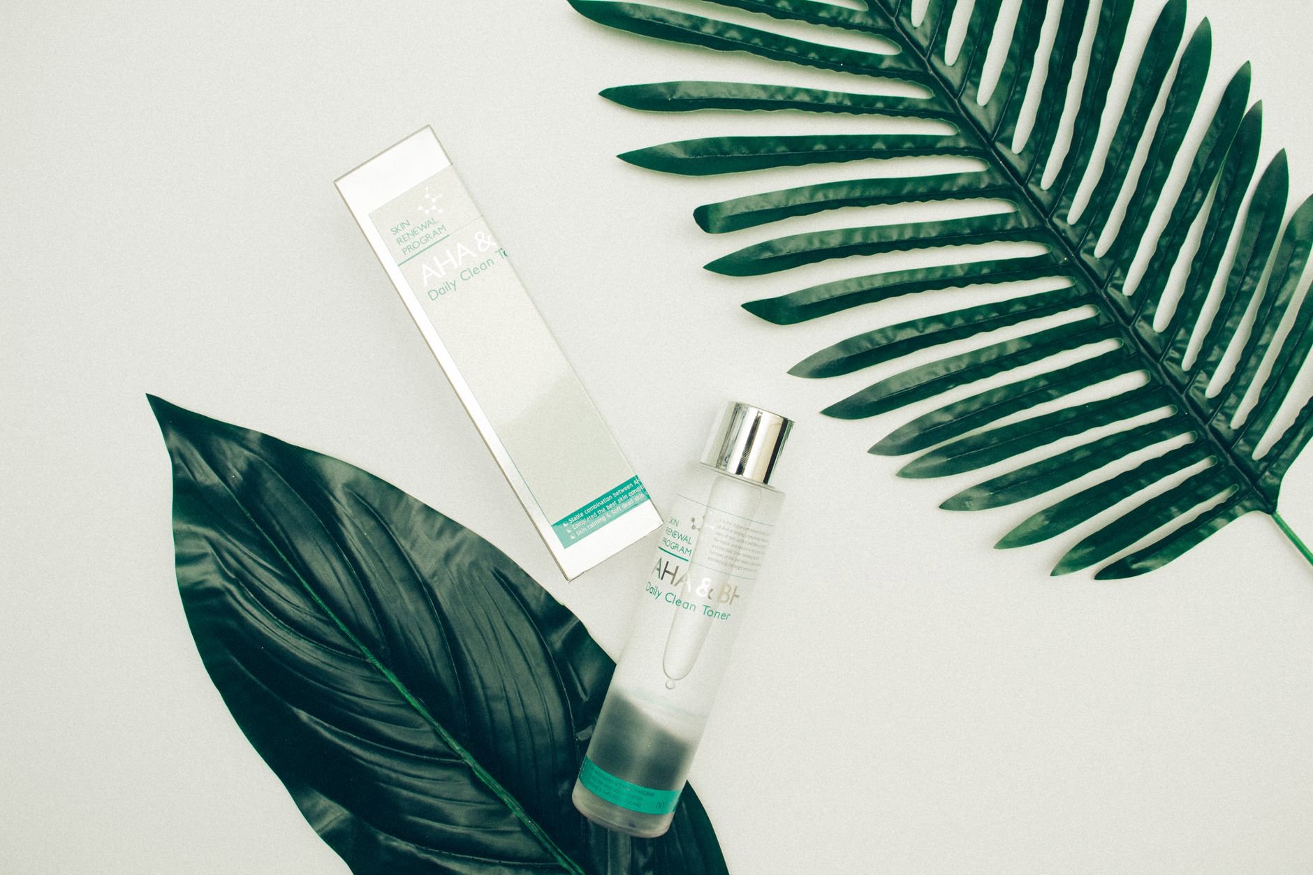 milky toner bottle skincare flatlay