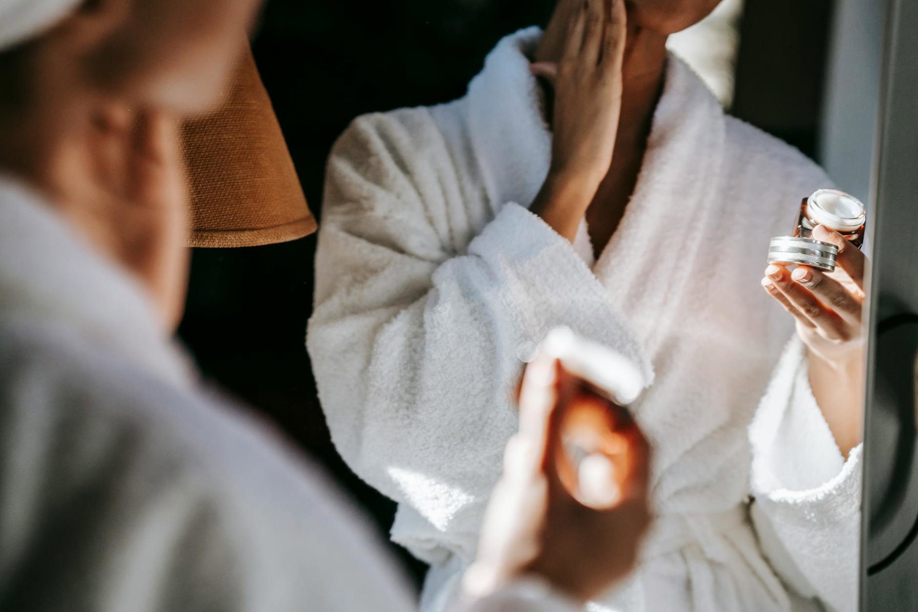 woman applying hydrating toner mirror