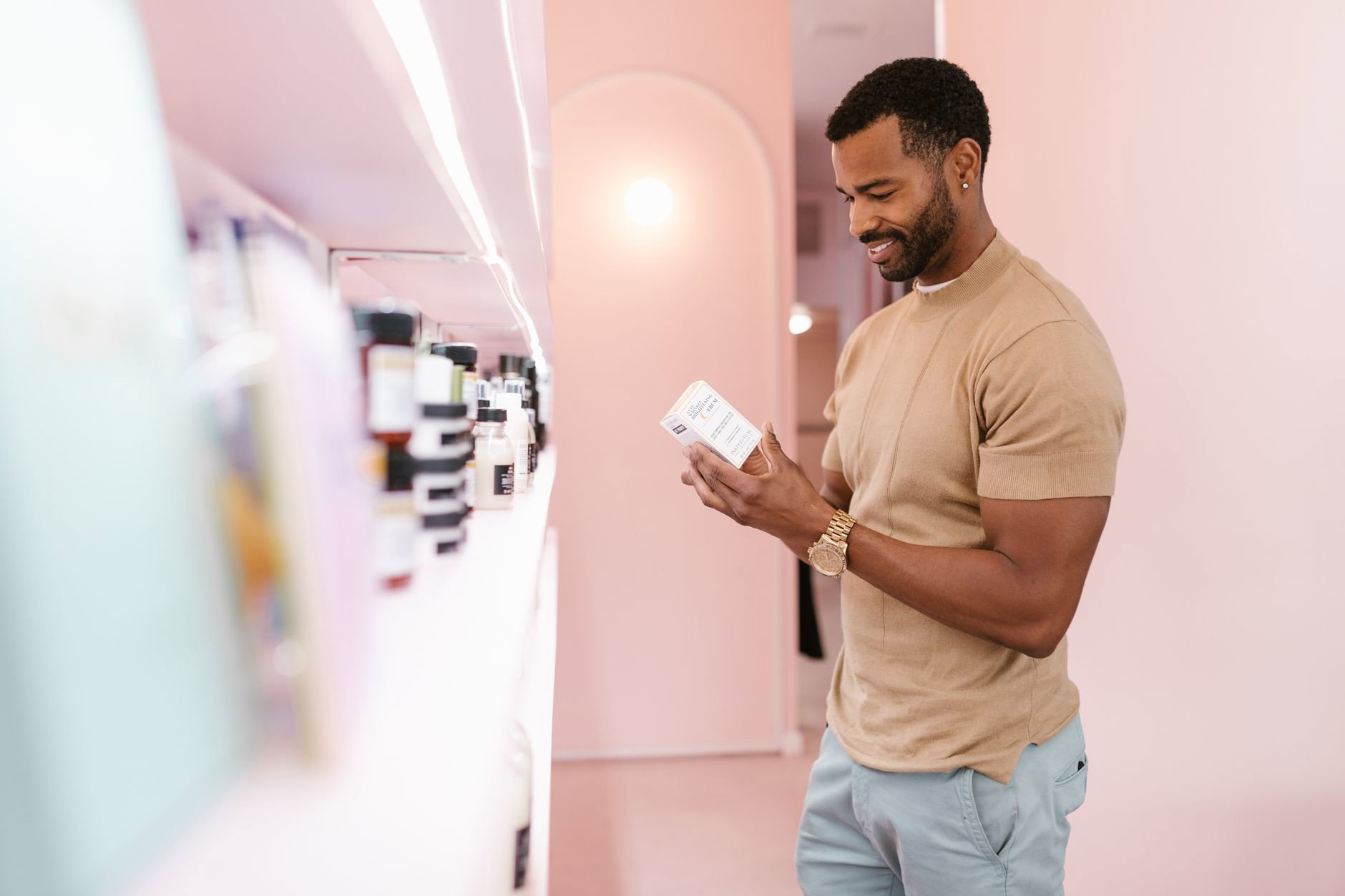 woman reading skincare ingredients label in store