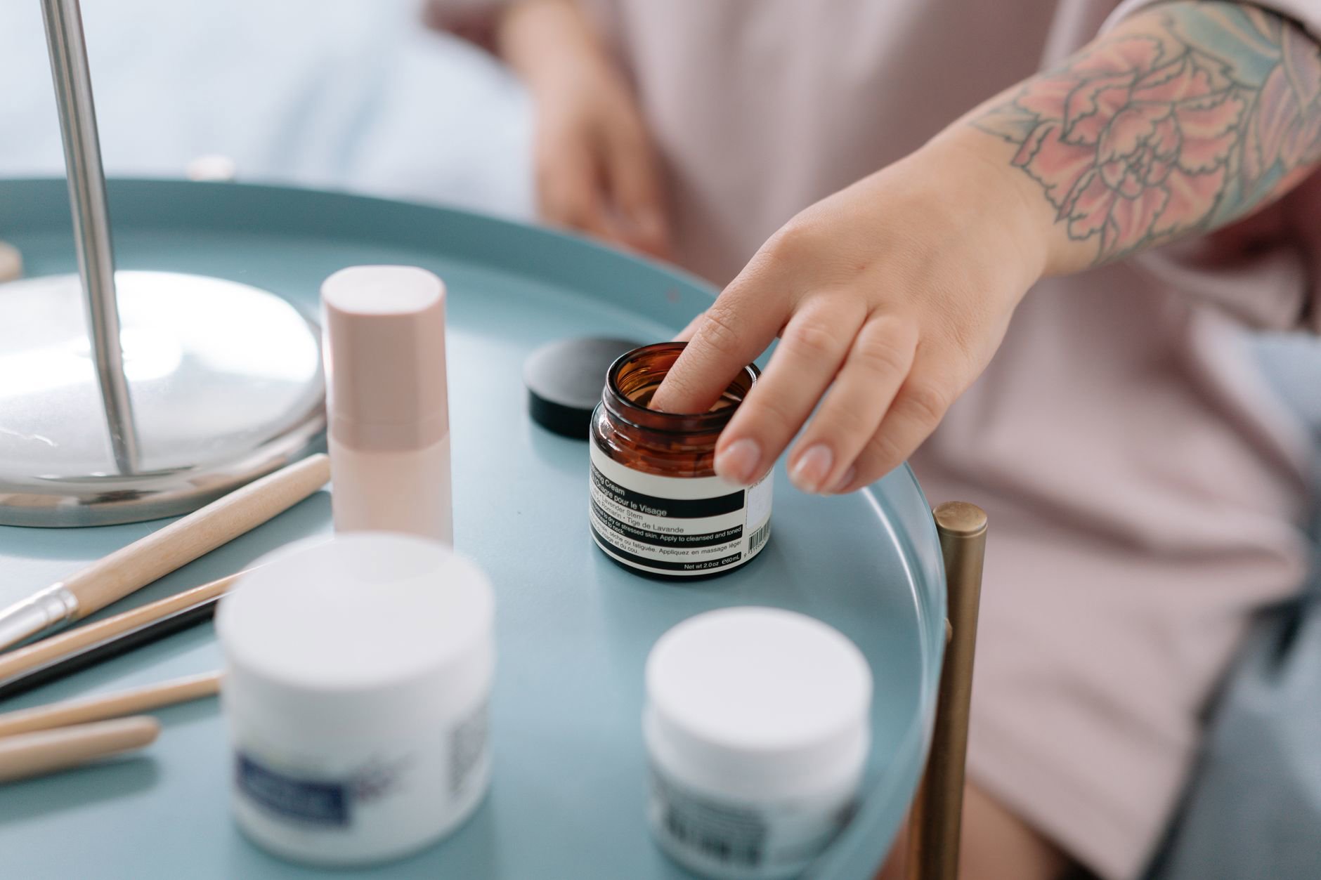 jar of night cream on bedside table