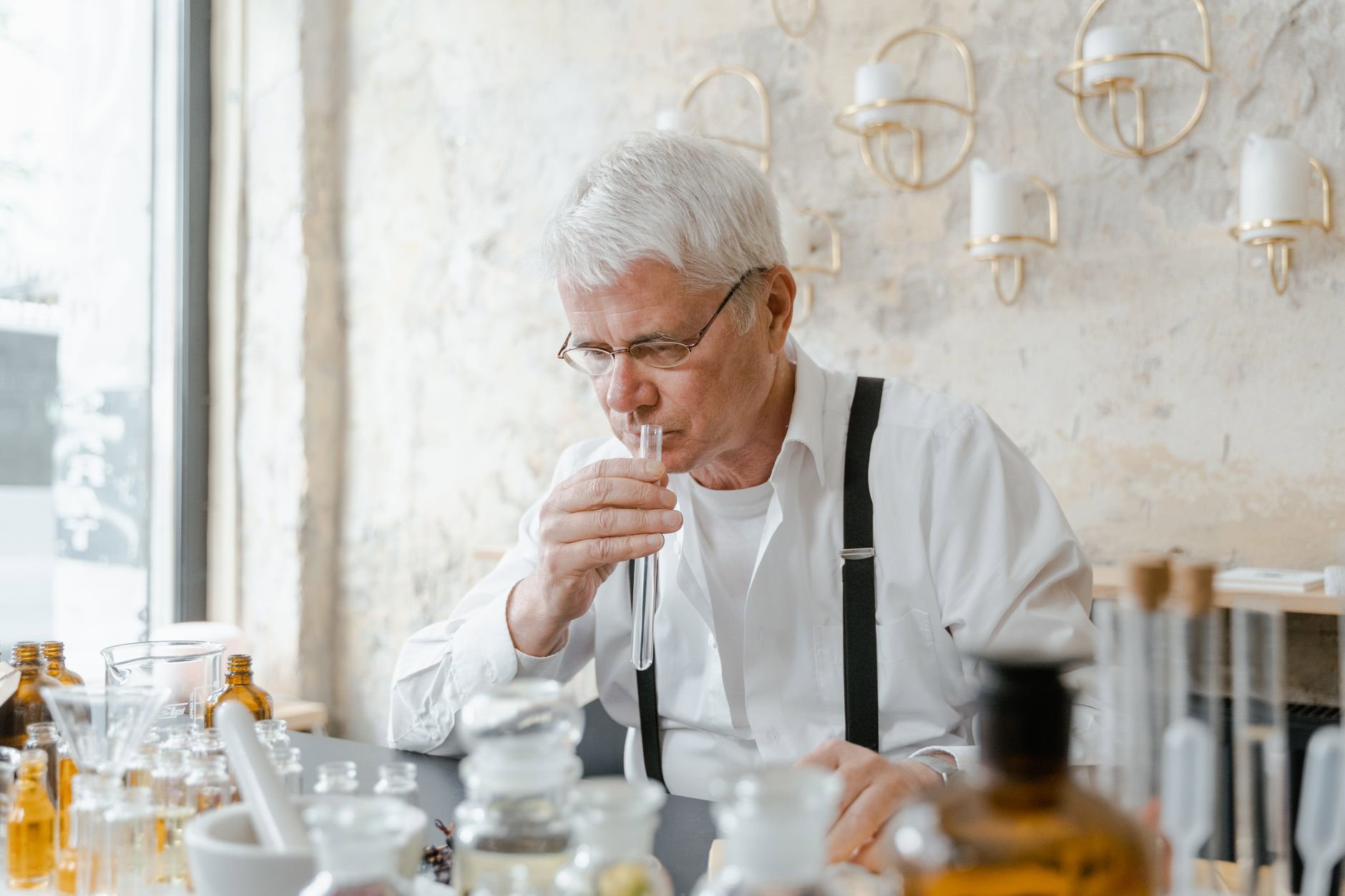 woman smelling perfume strip in french perfumery