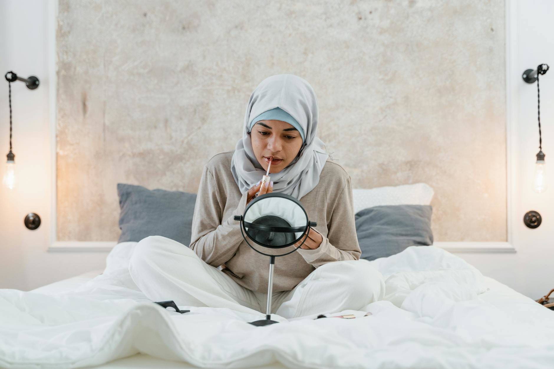 woman applying skin tint mirror