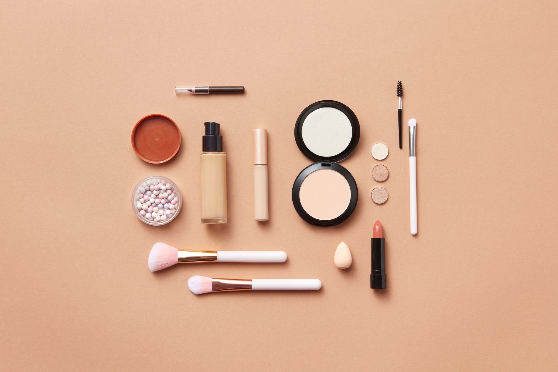 powder blush compact and brush flatlay