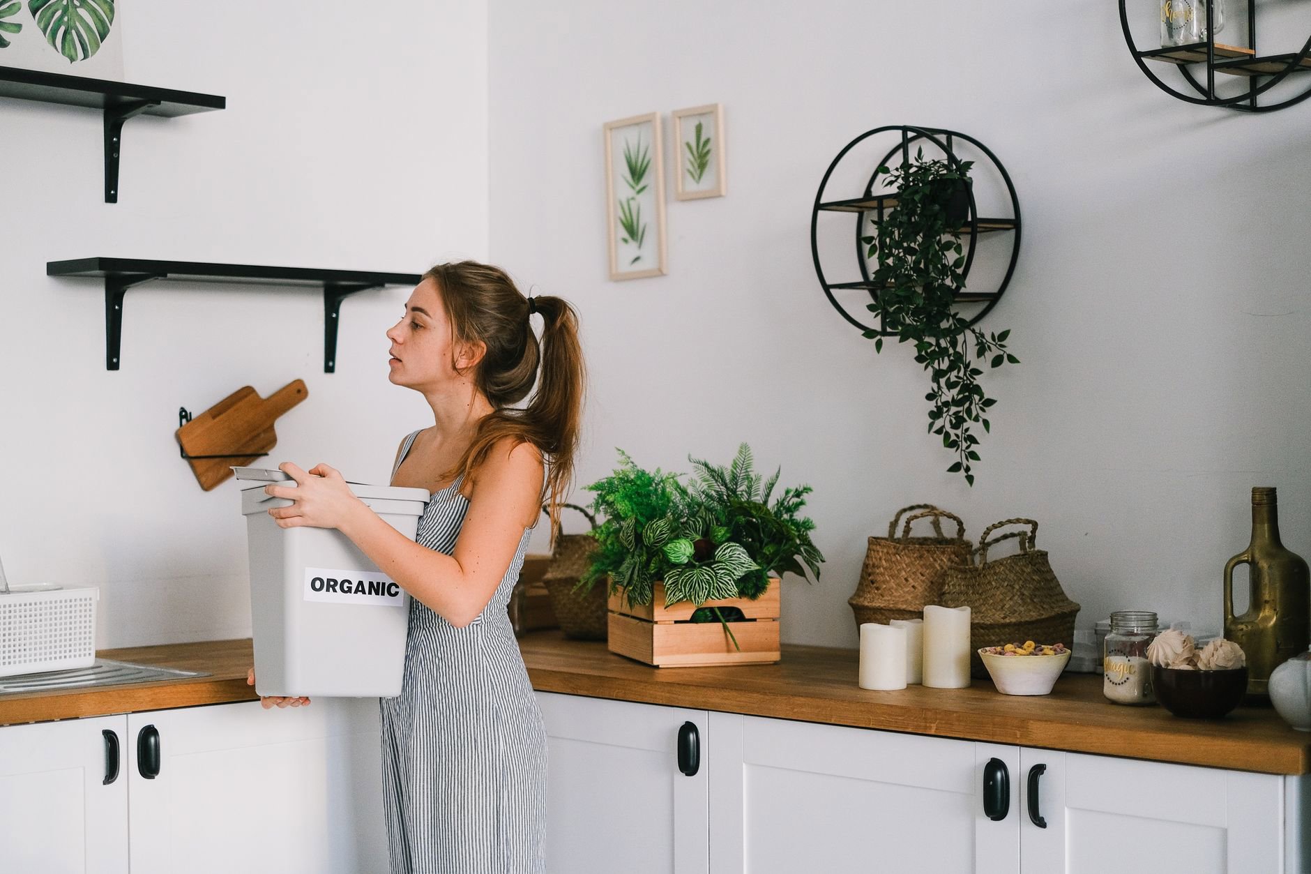 woman organizing skincare empties recycling bin
