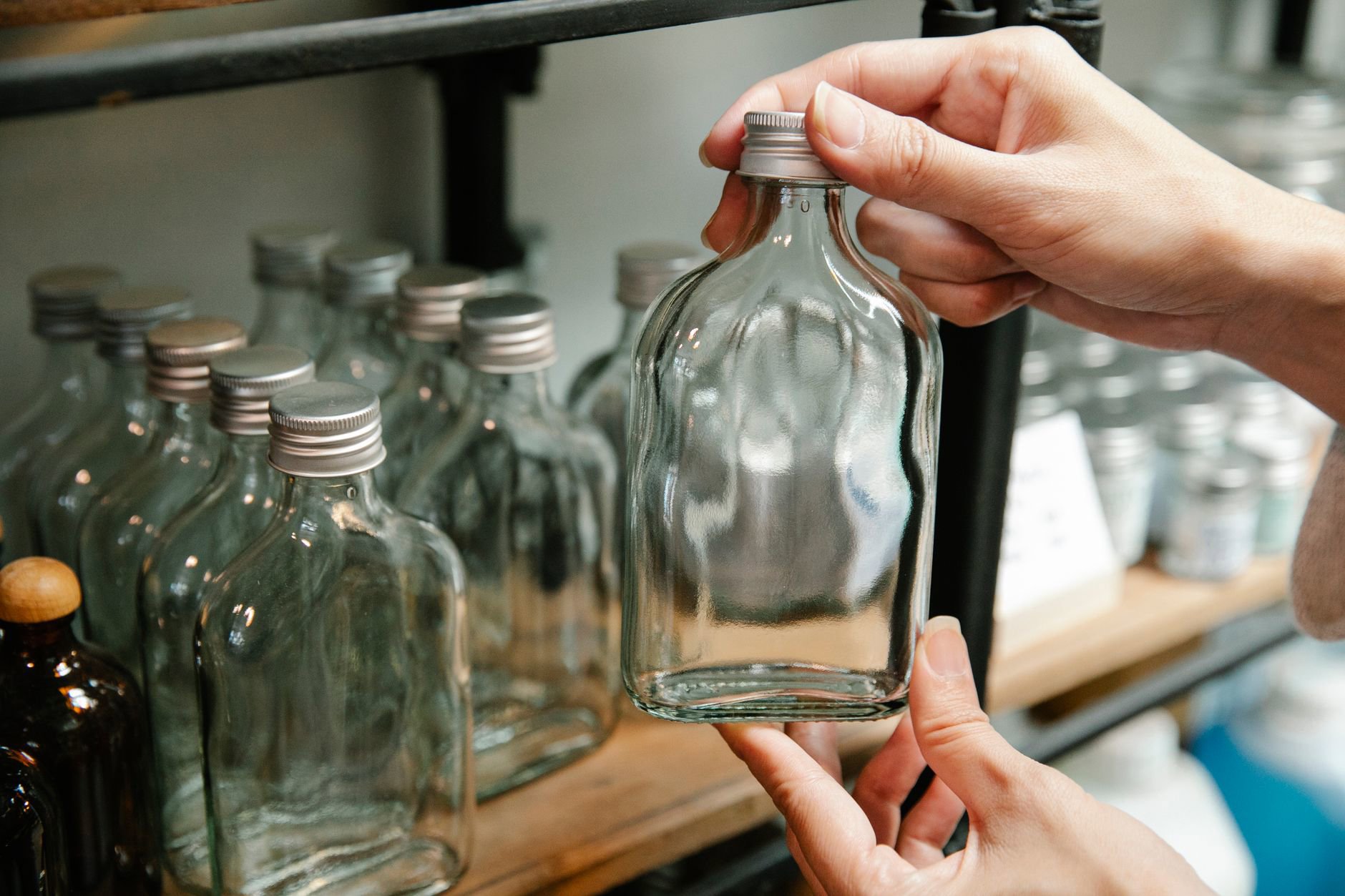 refillable skincare bottle on vanity woman hands
