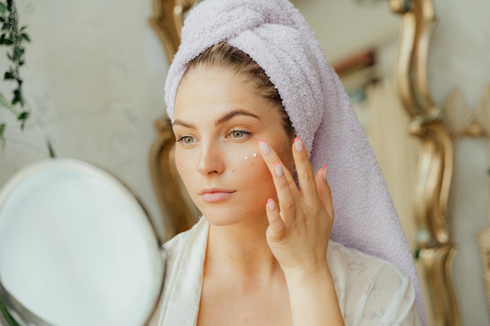 woman applying cream eye shadow mirror